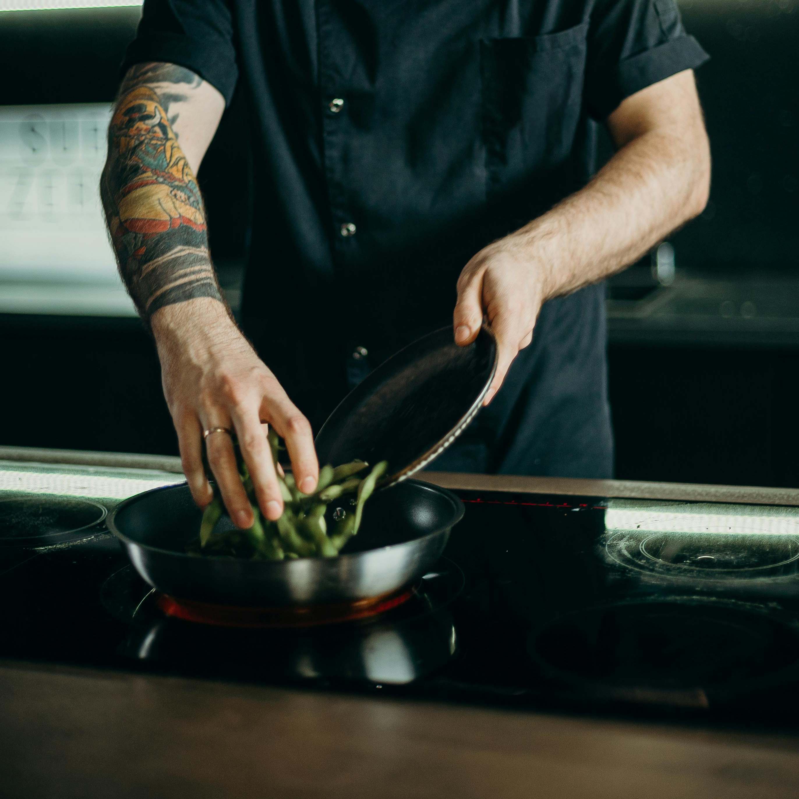 A man heating food in a pan | Source: Pexels