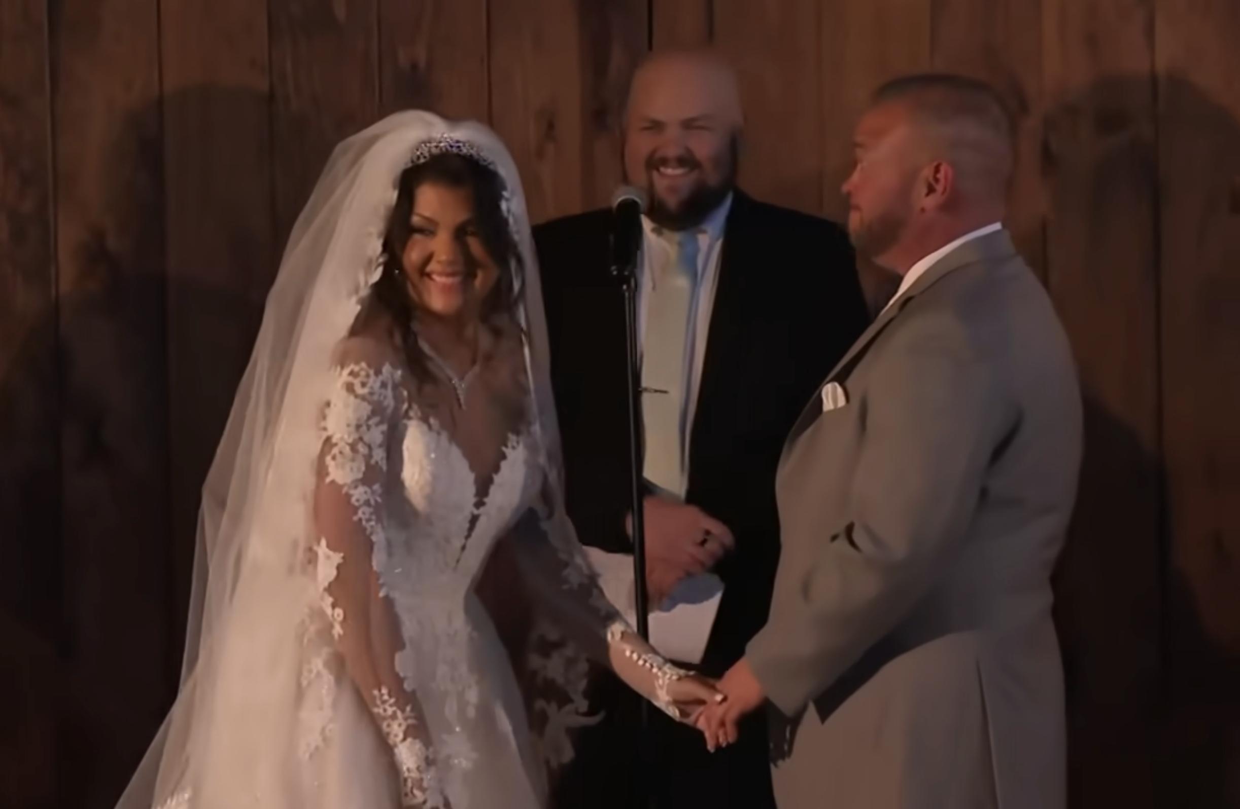 Stephanie Lebo smiles while holding hands with Jon Gosselin during their wedding ceremony, as posted on November 24, 2025 | Source: YouTube/EntertainmentTonight