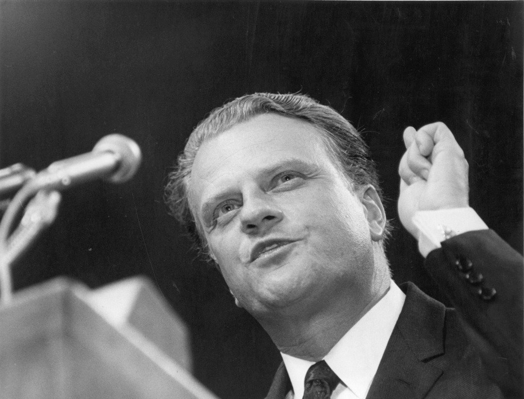 American evangelist Dr Billy Graham addressing the congregation at Earl's Court, London, at the beginning of his 32-day Greater London Crusader. | Source: Getty Images
