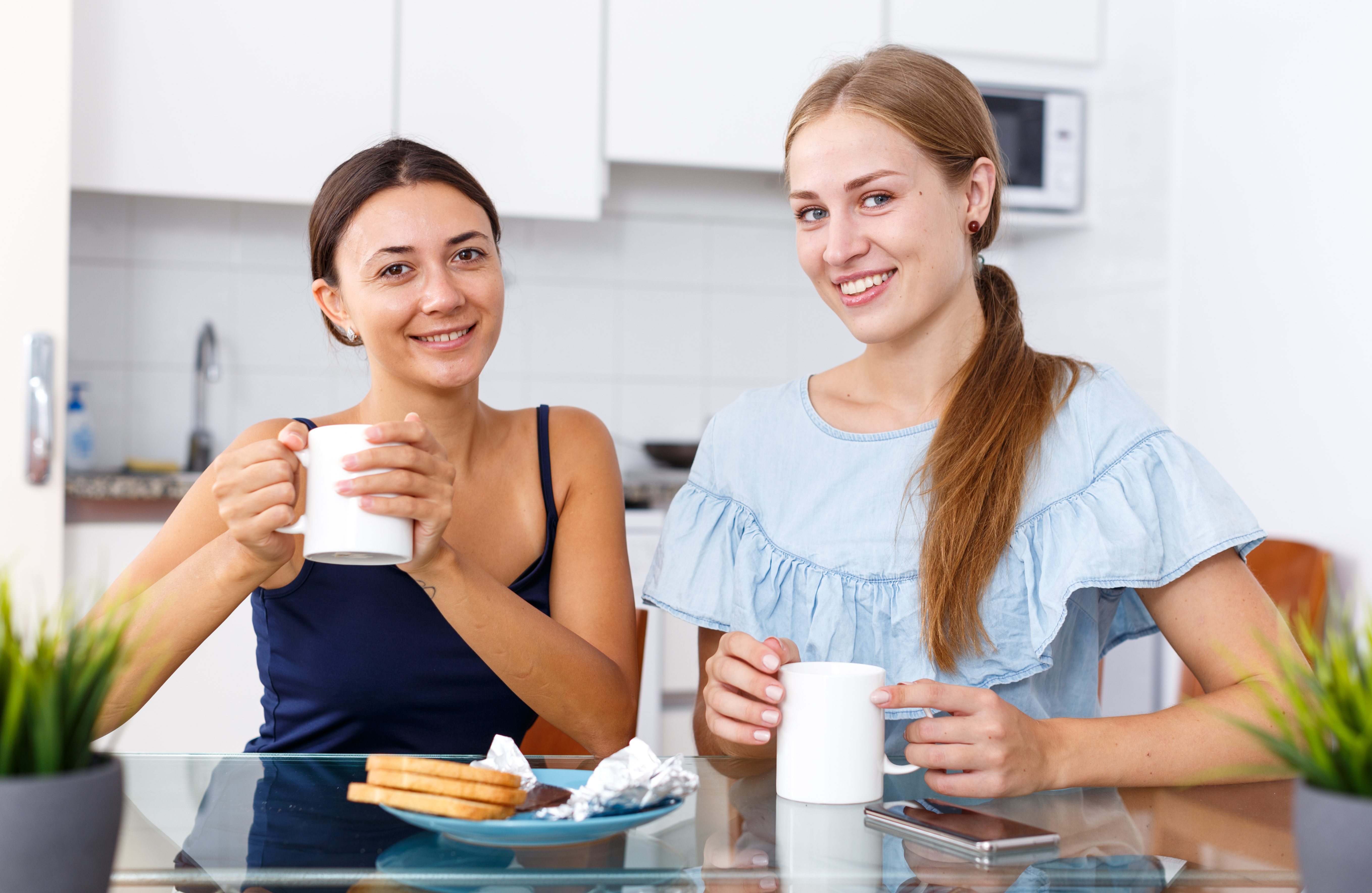Two women enjoying a hot drink | Source: Shutterstock