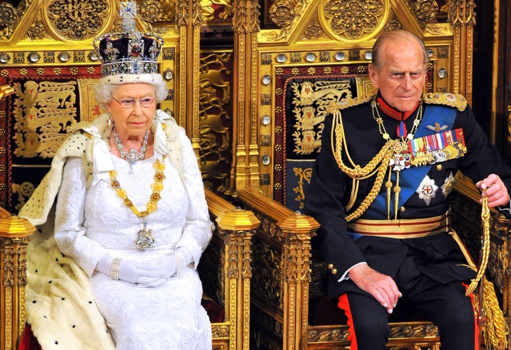  Queen Elizabeth II sits with Prince Philip, Duke of Edinburgh as she delivers her speech during the State Opening of Parliament in the House of Lords at the Palace of Westminster | Photo: Getty Images