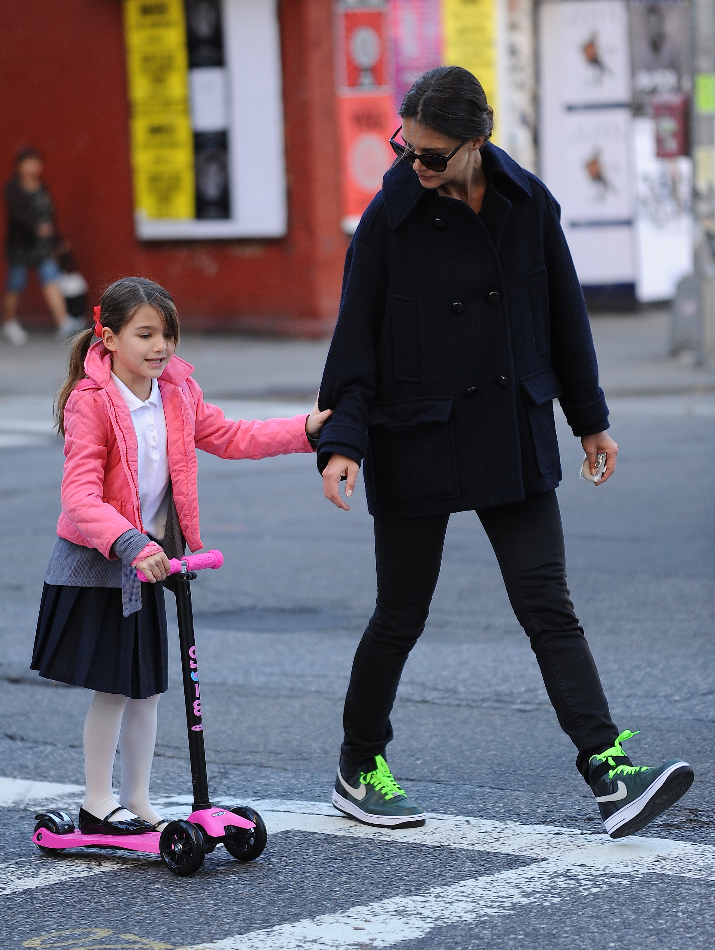 Katie Holmes sighted helping Suri Cruise to scooter in New York City, on October 8, 2013. | Source: Getty Images