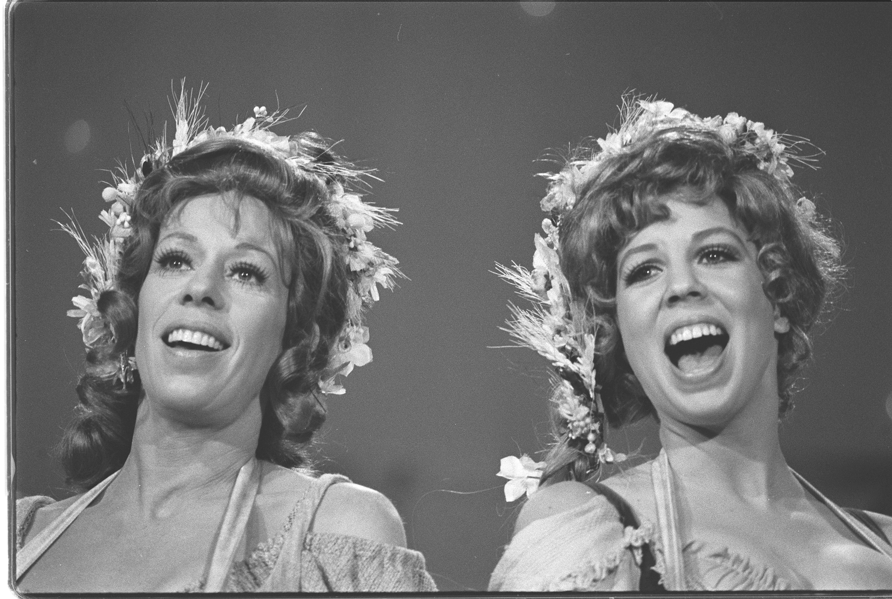 Carol Burnett and Vicki Lawrence singing, wearing flowers in their hair, in a musical skit from 'The Carol Burnett Show' in September 1973.  | Source: Getty Images