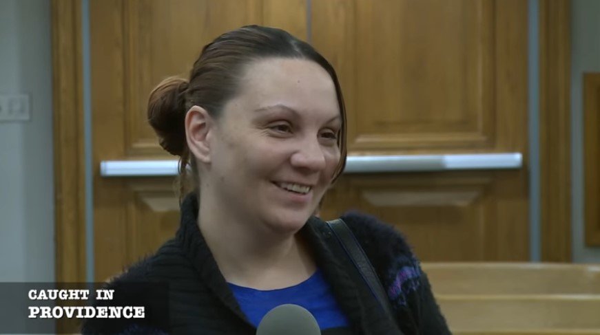 Female defendant laughing during her court hearing | Source: Youtube/ Caught In Providence