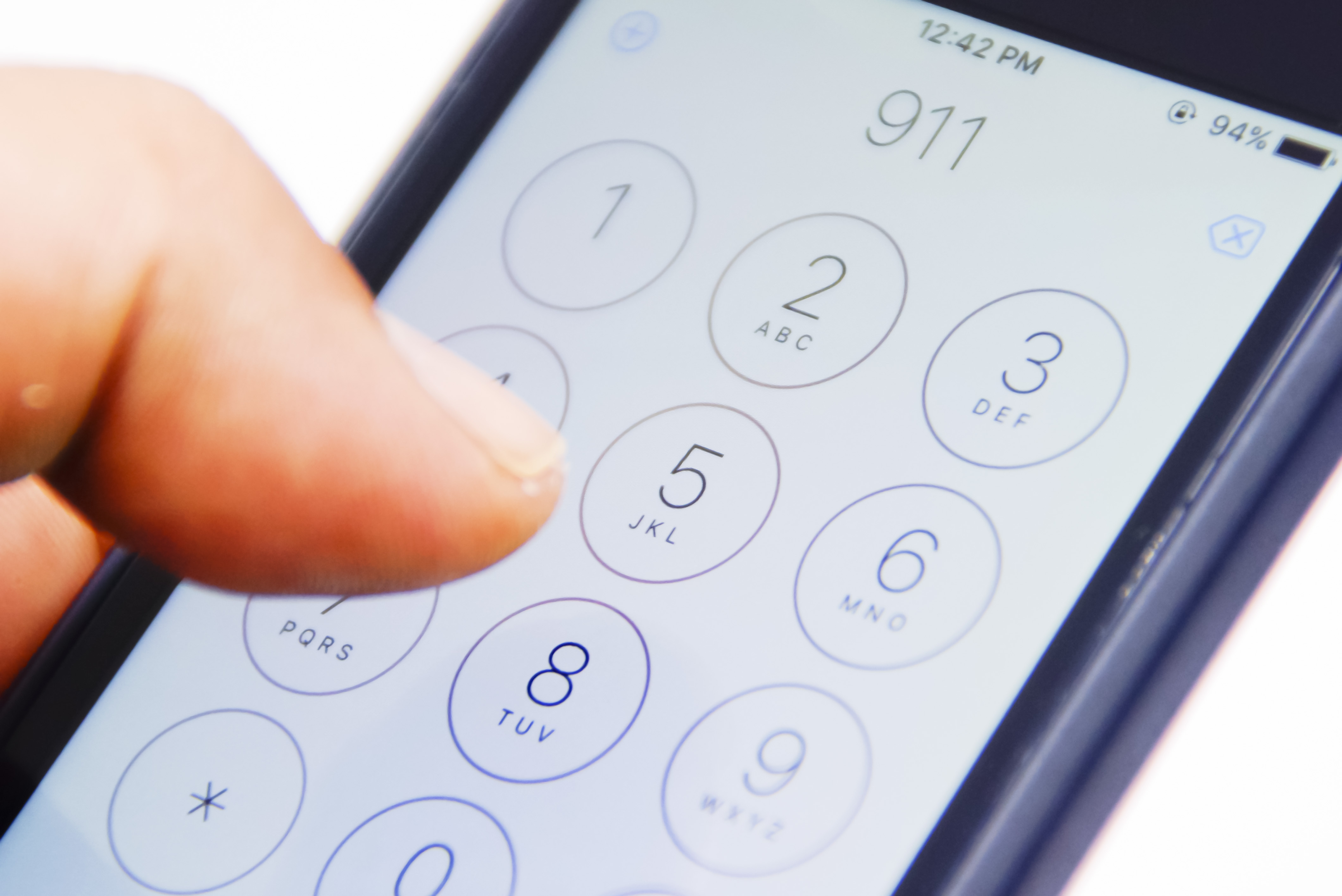 A person dialing 911 on their phone | Source: Shutterstock
