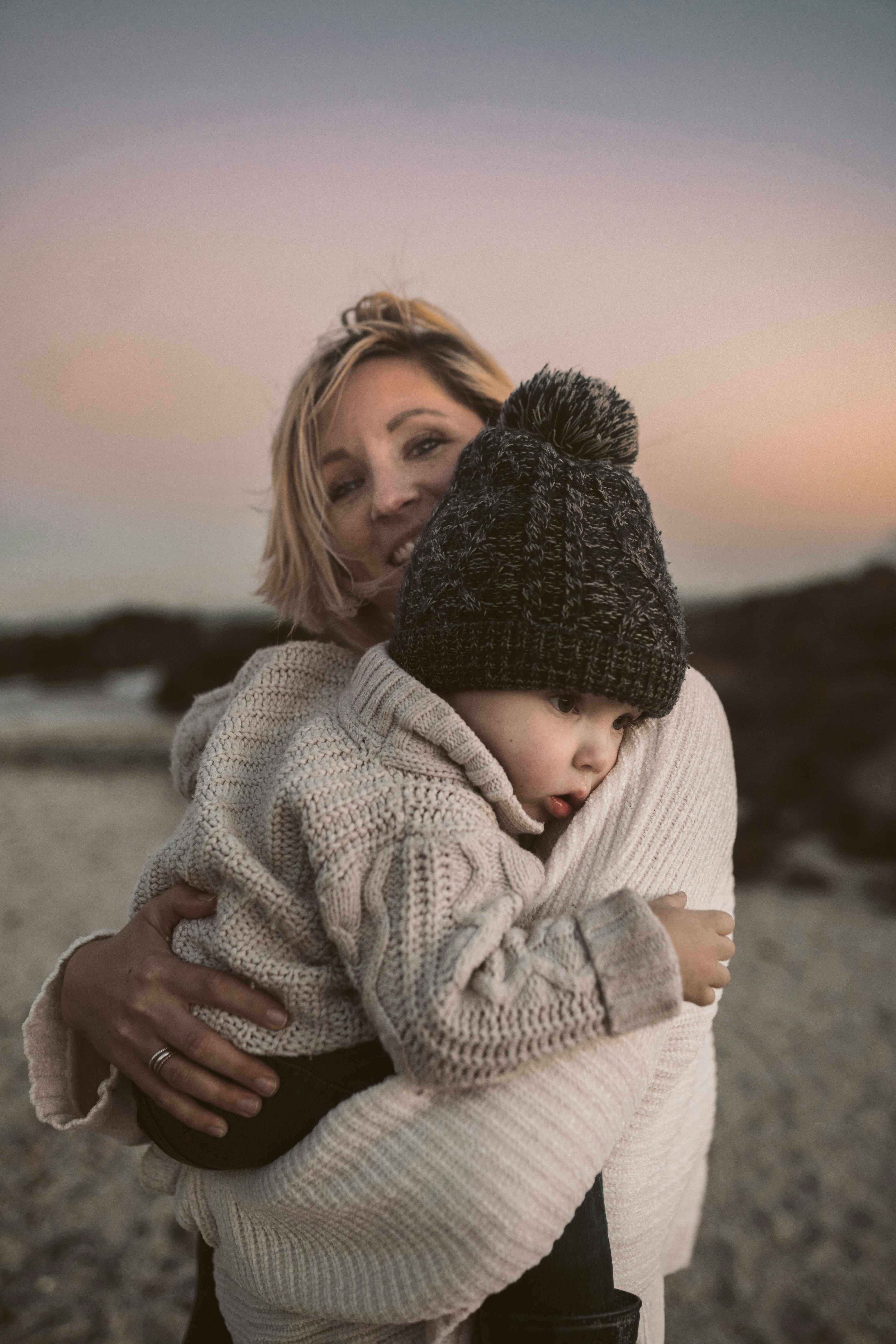 Woman and her baby on the beach | Source: Pexels