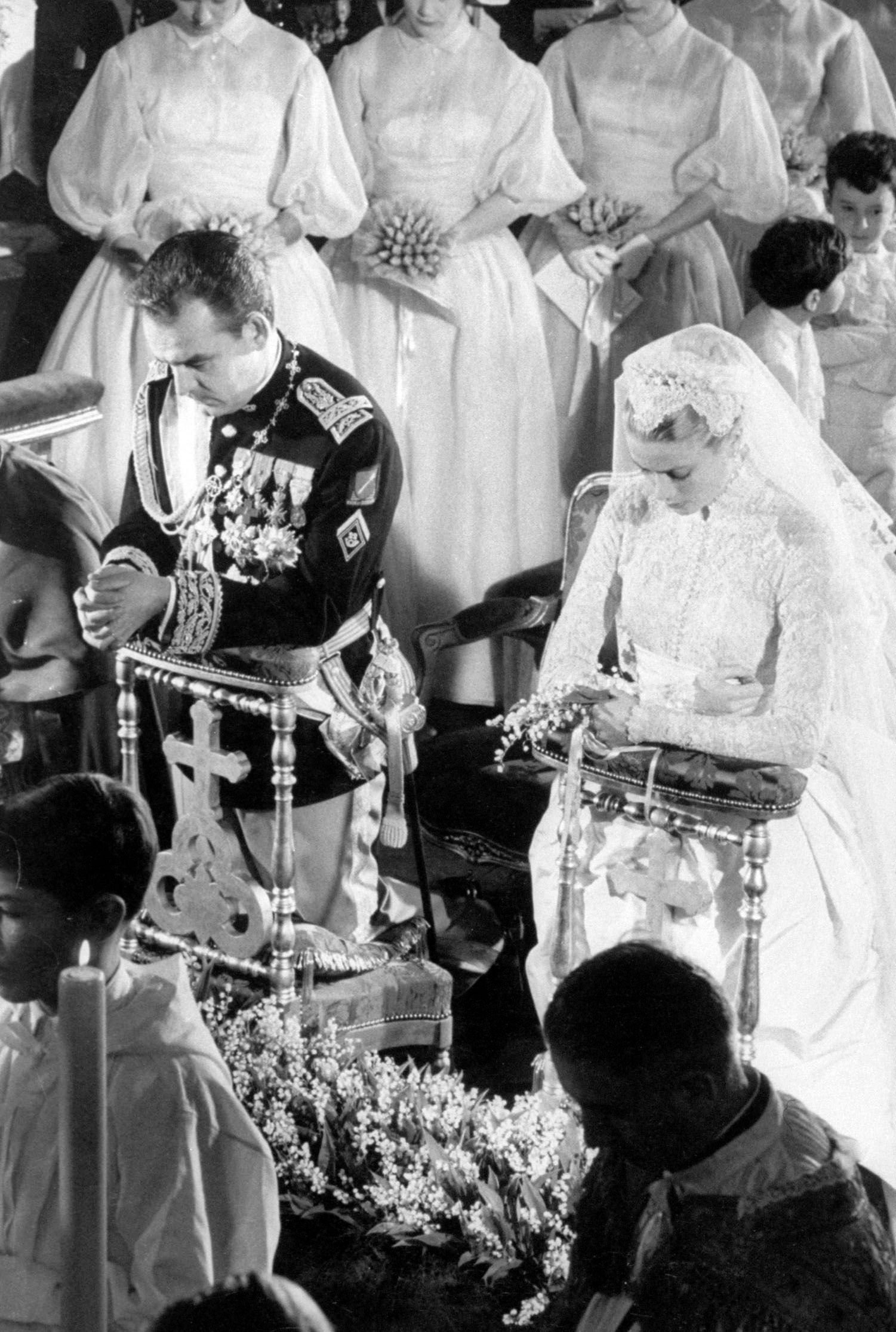 Prince Rainier kneeling during Mass in the Cathedral while marrying Grace Kelly in 1956, in Monaco. | Source: Thomas D. Mcavoy/The LIFE Picture Collection/Getty Images