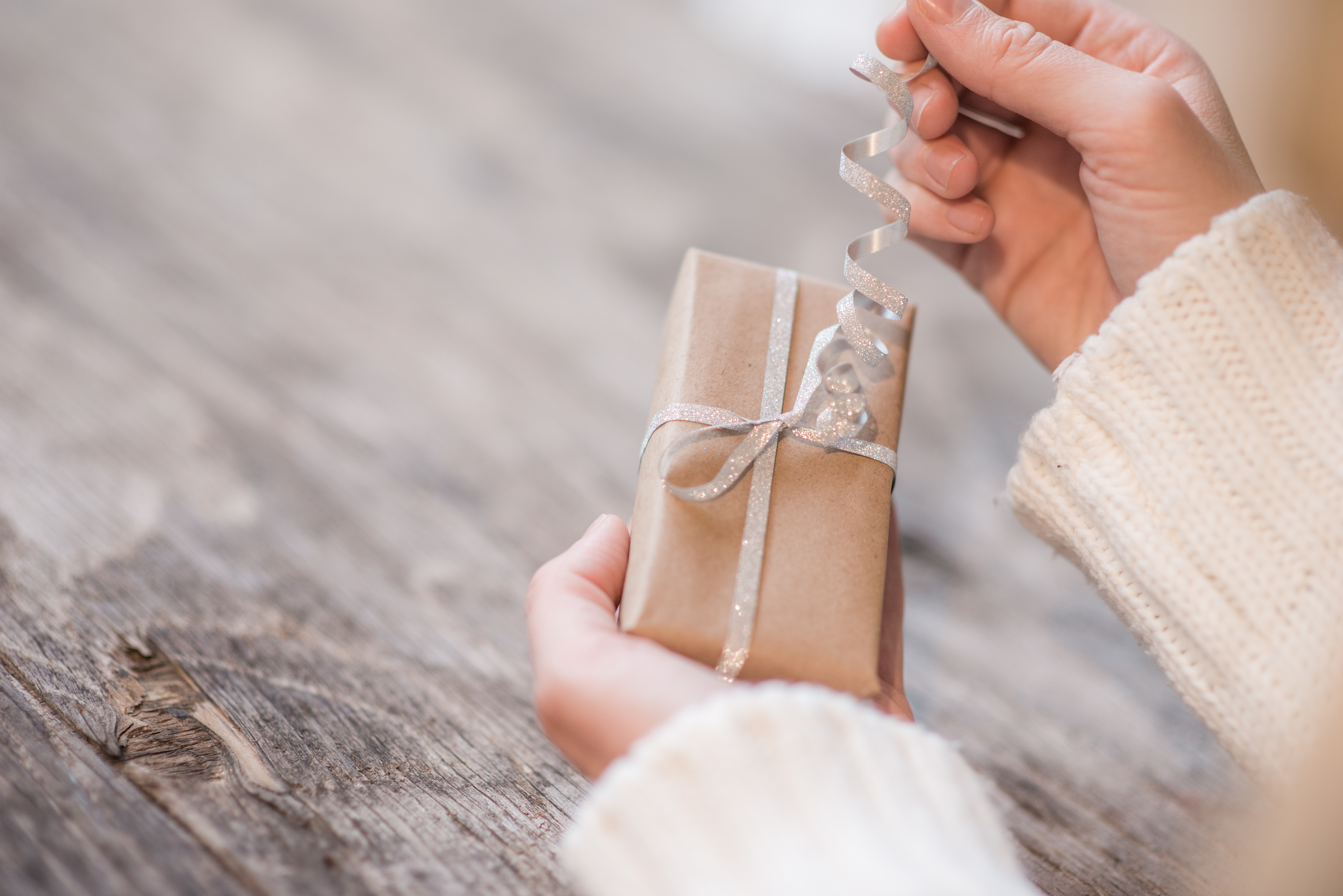 A woman opening a gift | Source: Shutterstock