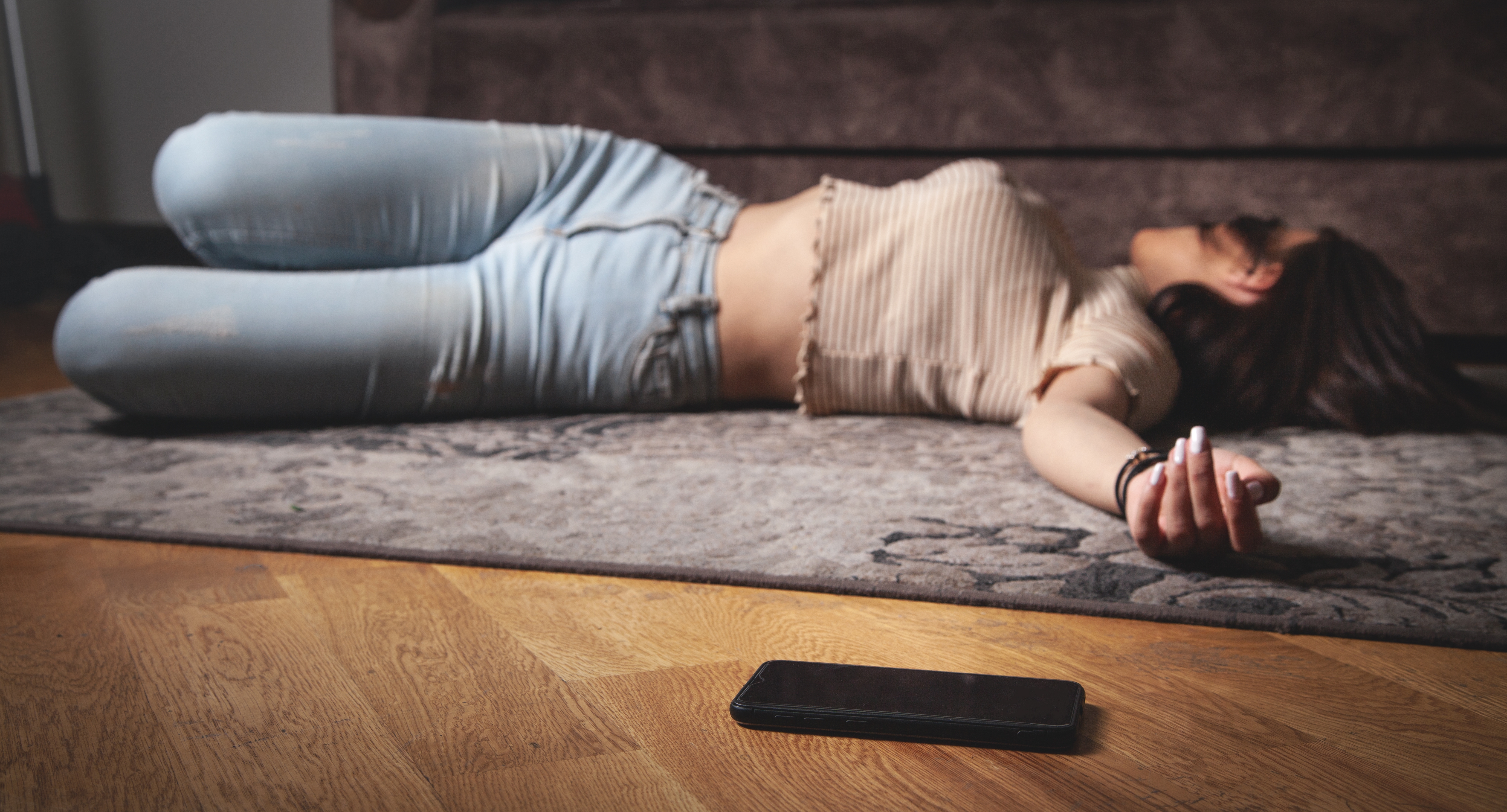 Unconscious young woman lying on floor. | Source: Shutterstock
