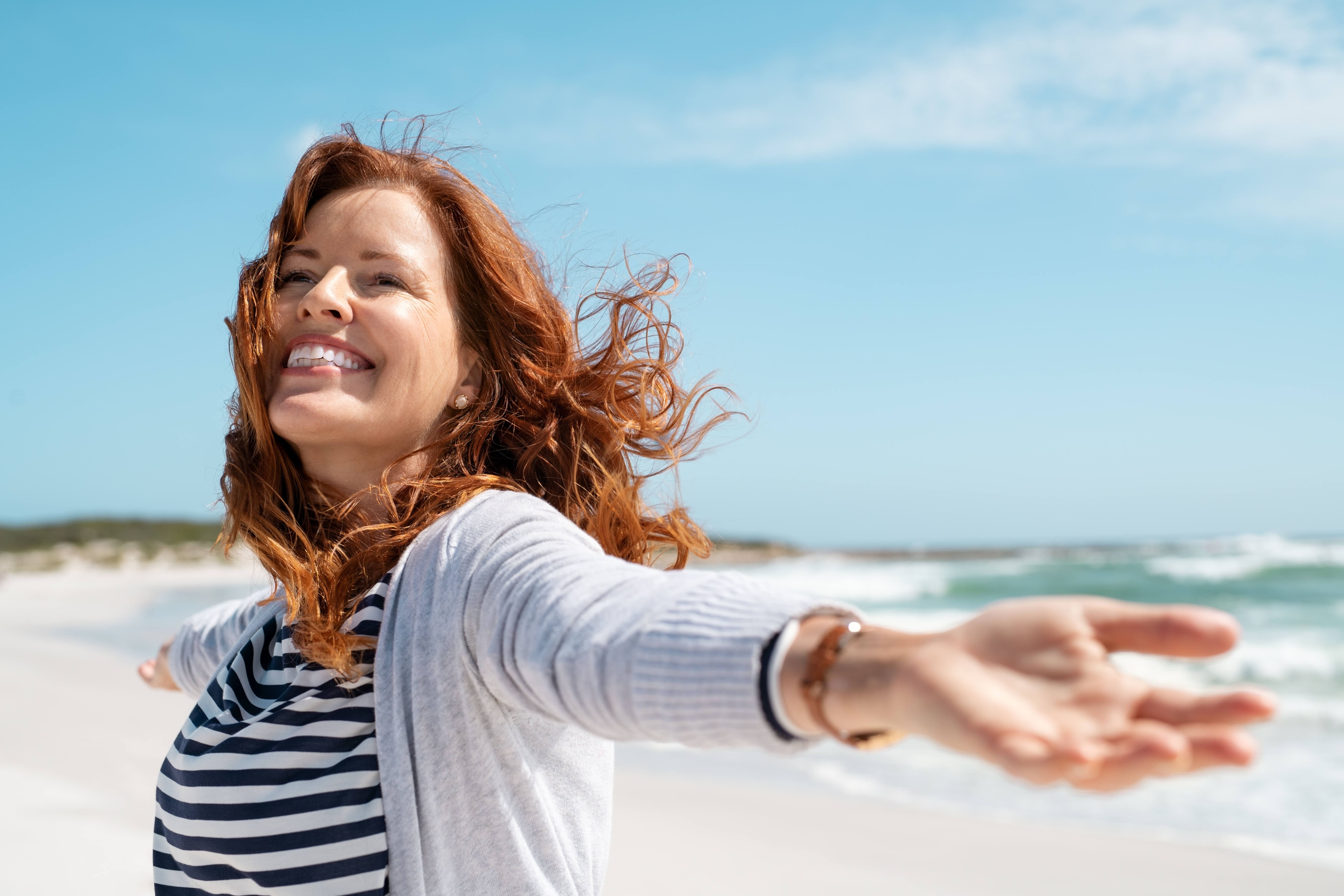 A happy woman on the seaside | Source: Shutterstock