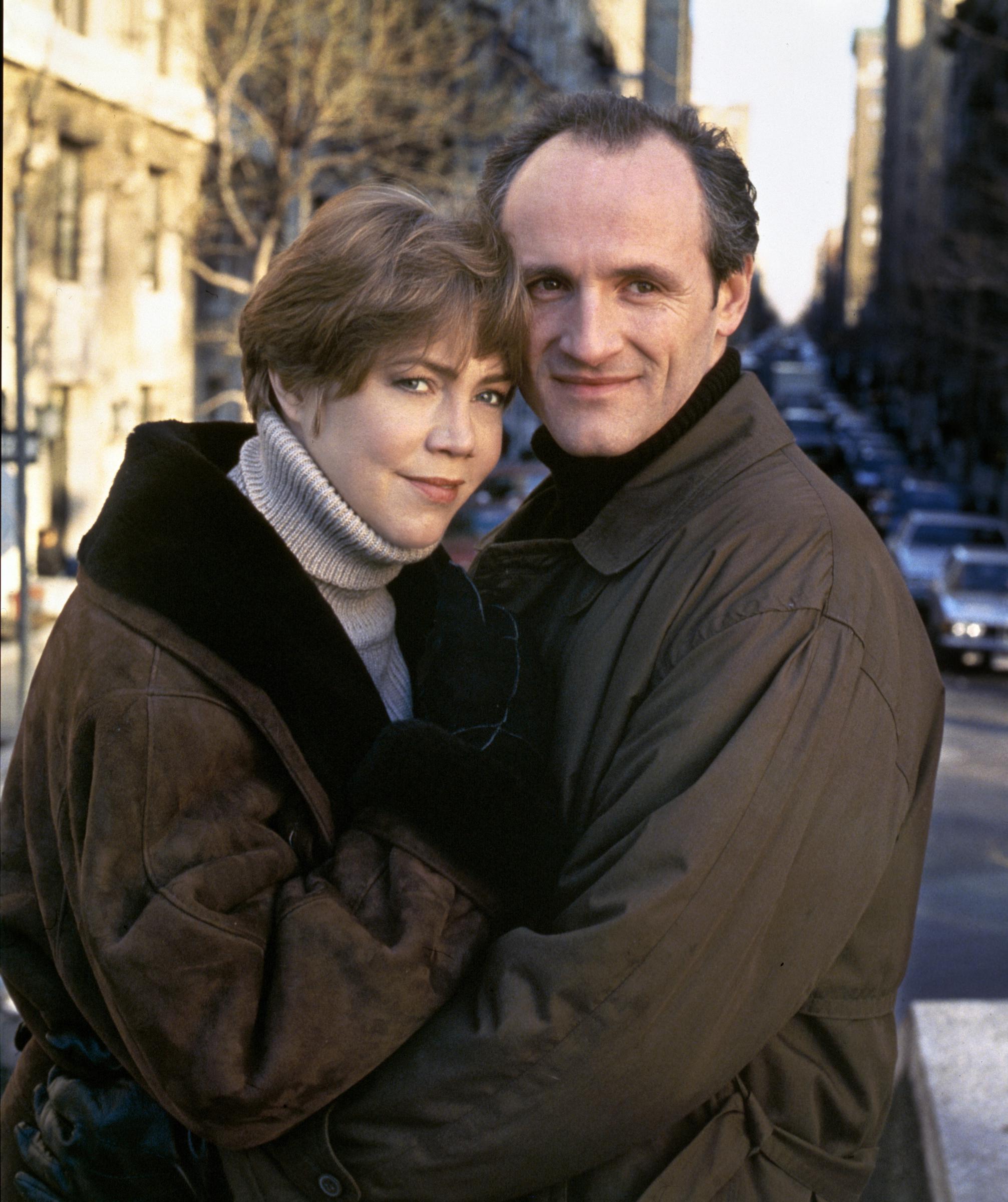 A promotional still from the made-for-TV movie "Friends At Last" shows Kathleen Turner as Fanny Connelyn and Colm Feore as Phillip Connelyn embracing warmly on a city street. The film, which explores themes of marriage, divorce, and friendship, marked Turner's network television film debut.