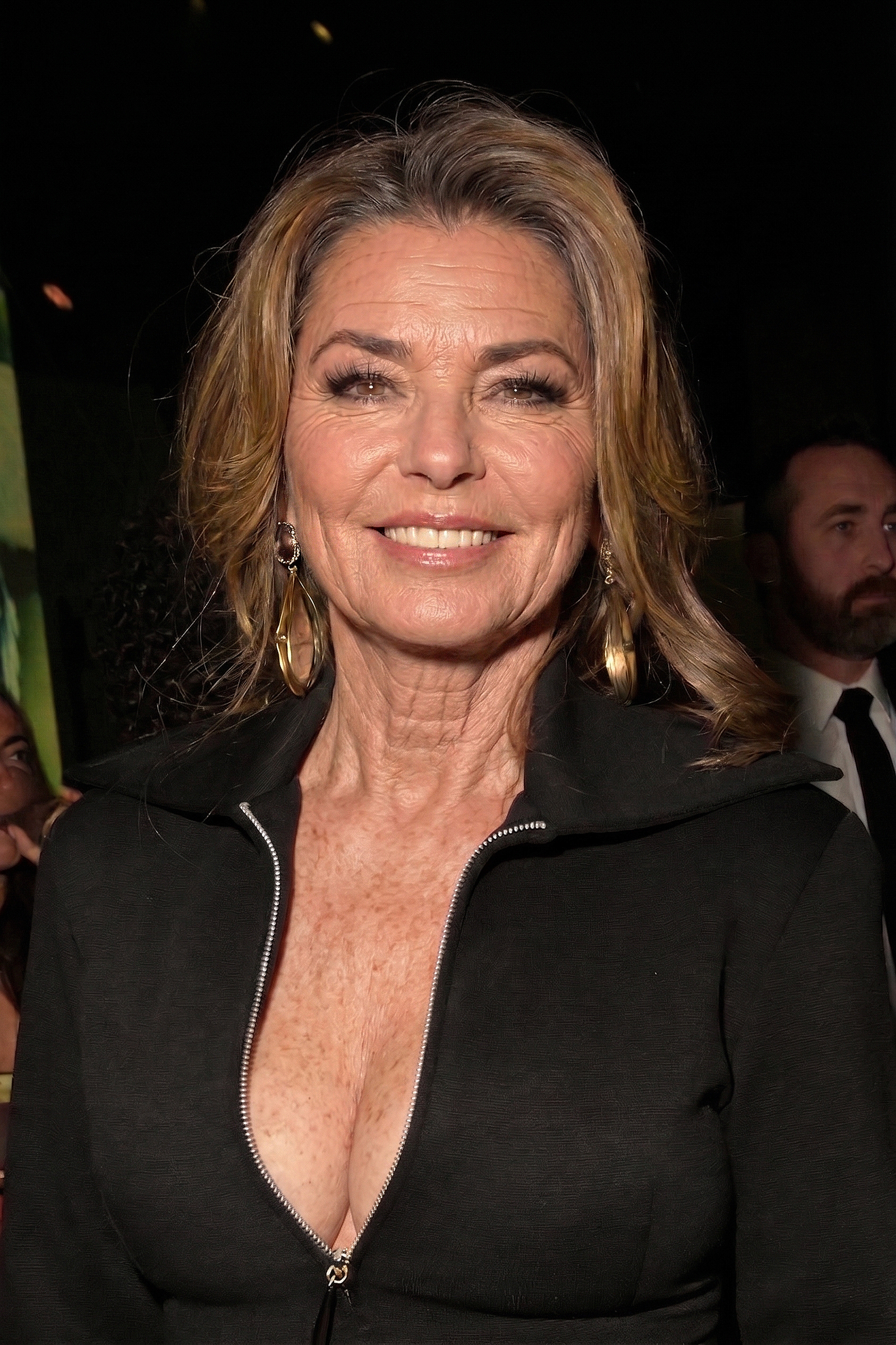 Based on Shania Twain's February 1, 2026 GRAMMY after-party appearance, this AI-generated edit focuses on unretouched skin textures, showcasing pronounced smile lines, subtle grey strands, and natural neck and décolletage details. | Source: Gemini