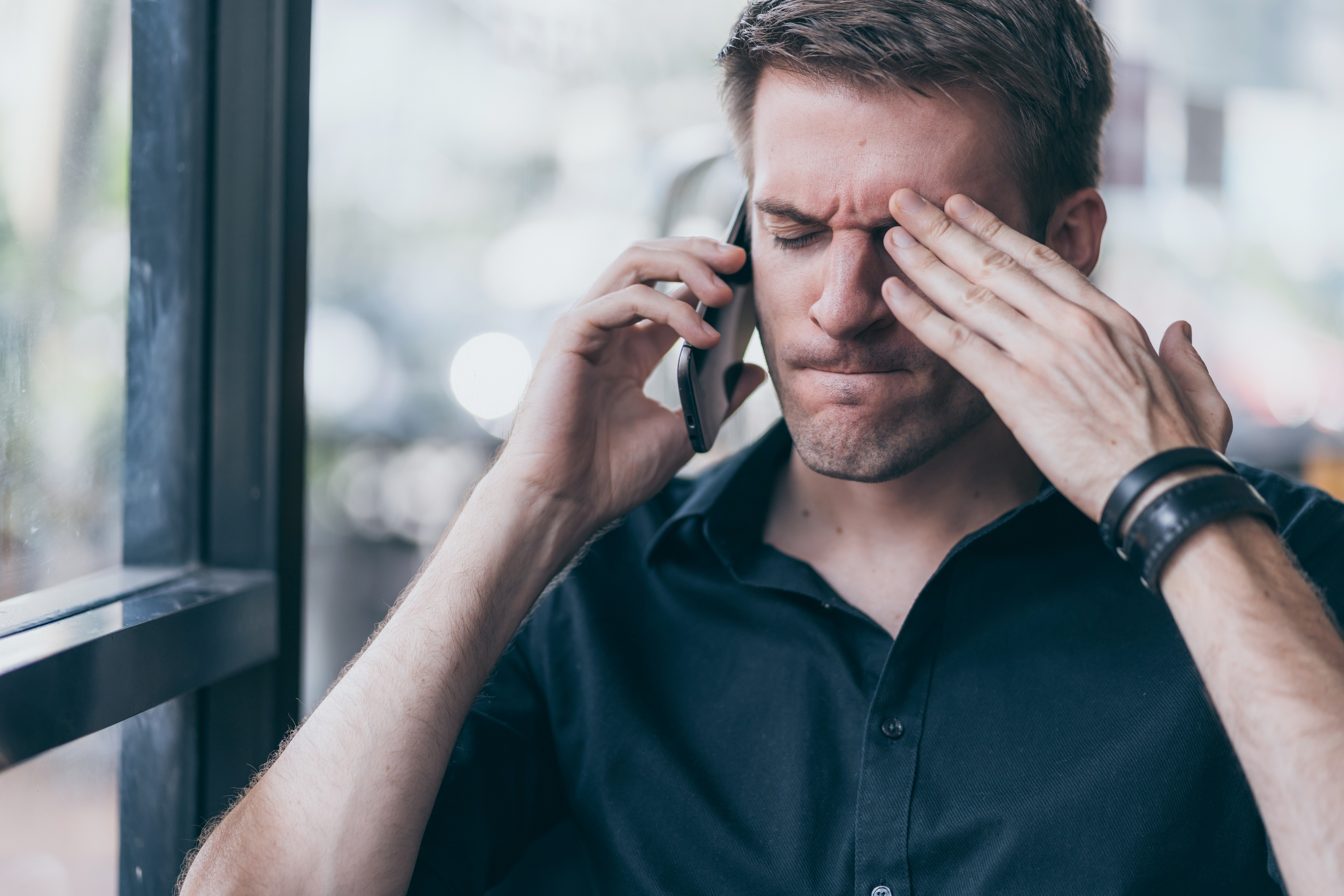 A stressful man talking on the phone | Source: Shutterstock