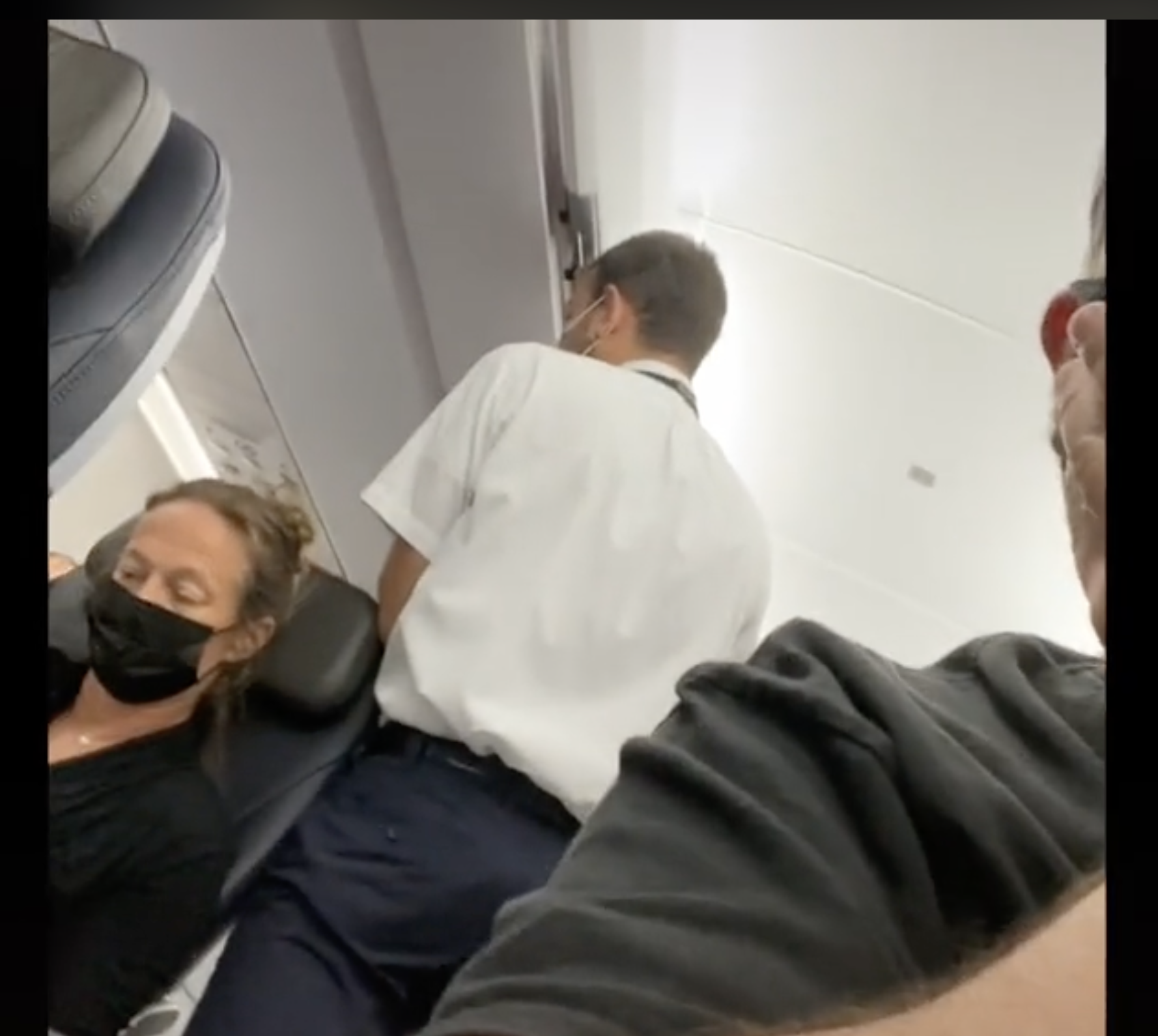 Eine der Flugbegleiterinnen ist im Gespräch mit einem angeblich widerspenstigen Passagier während des Fluges zu sehen. | Quelle: tiktok.com/@brentunderwood