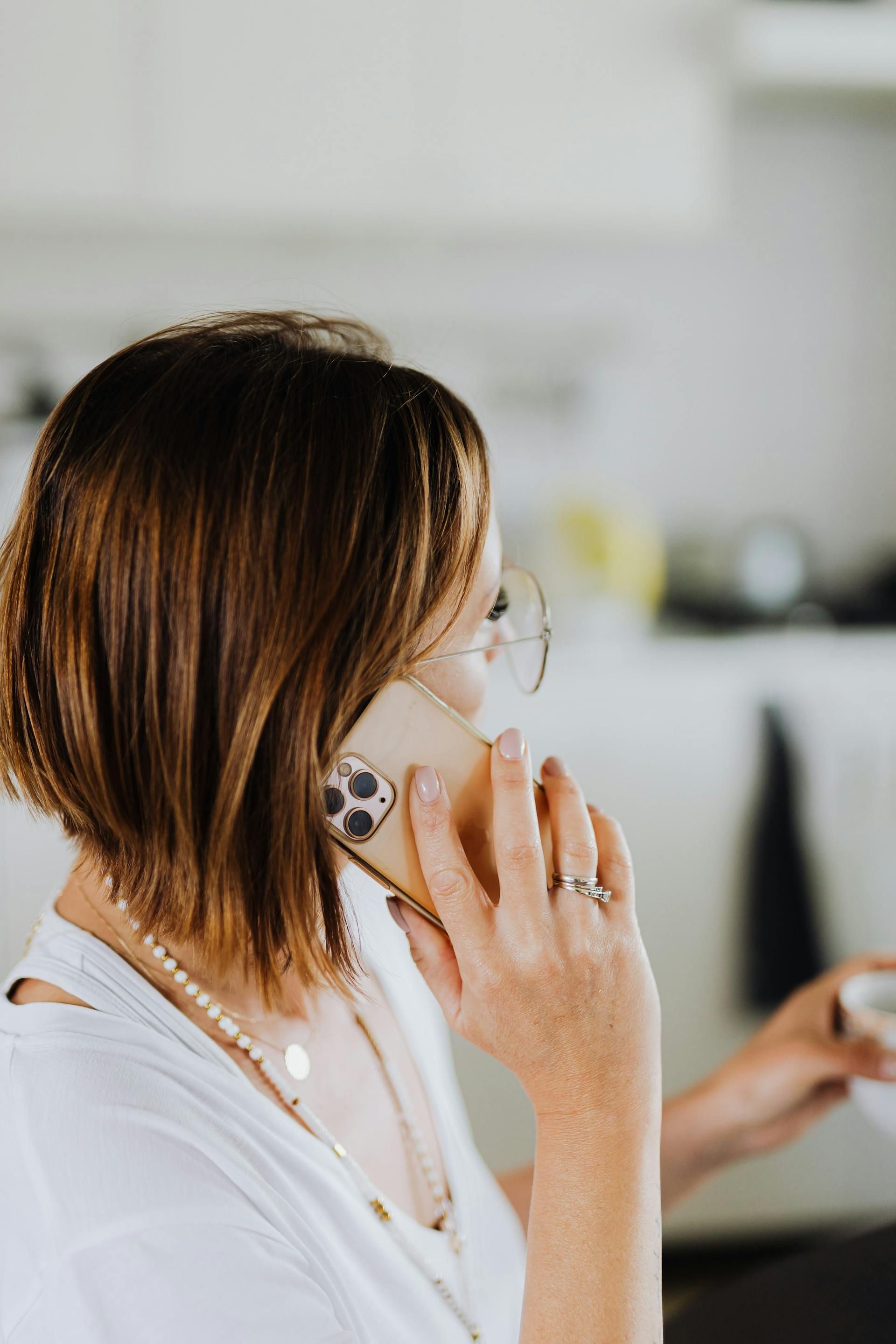 A woman talking on her phone at home | Source: Pexels