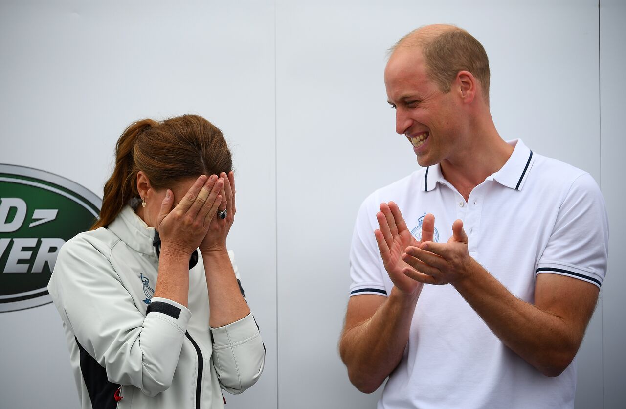 Kate Middleton buries her face in her hands as she is awarded a big wooden spoon at the King's Cup charity race. | Source: Getty Images