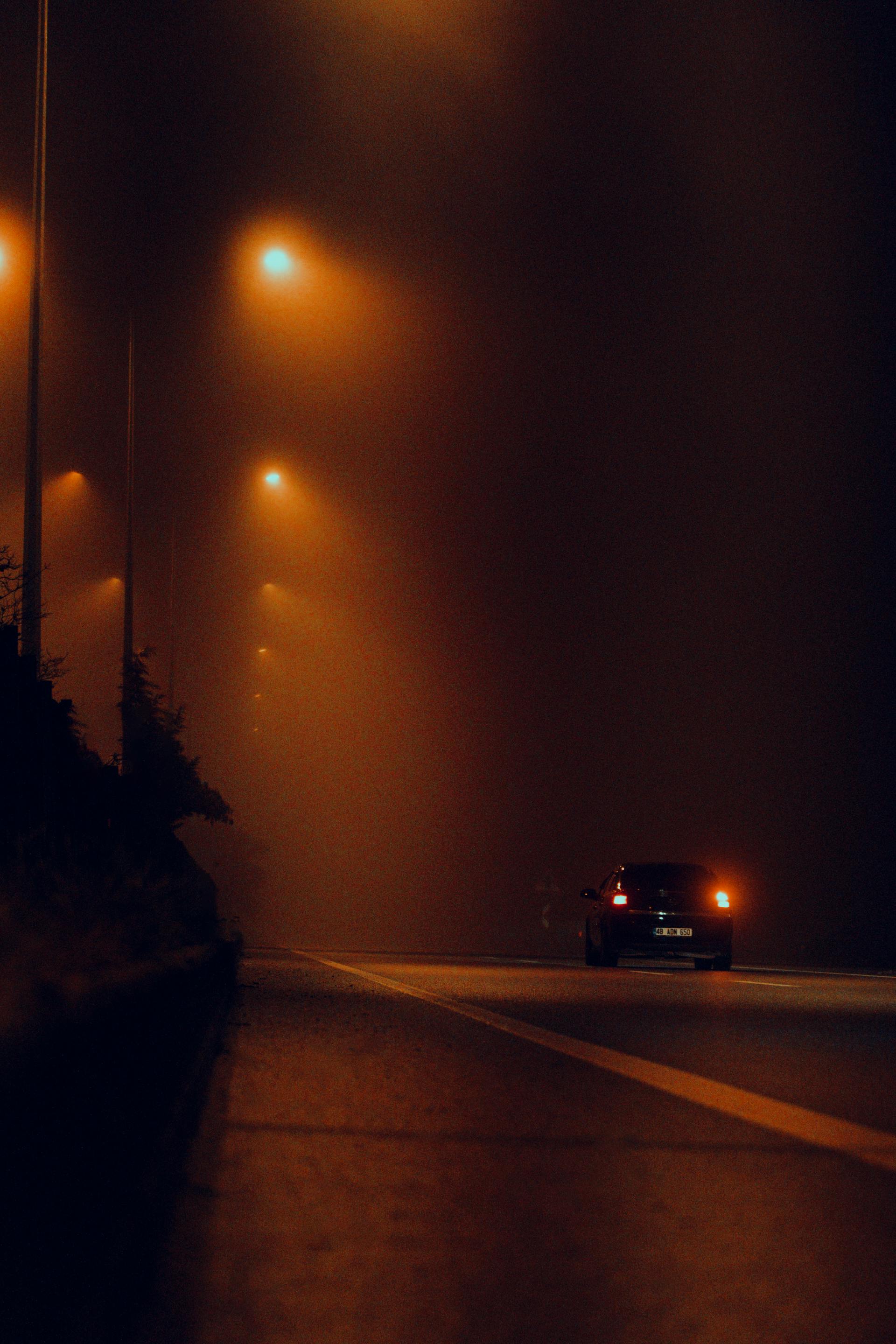 A car driving down the road at night | Source: Pexels