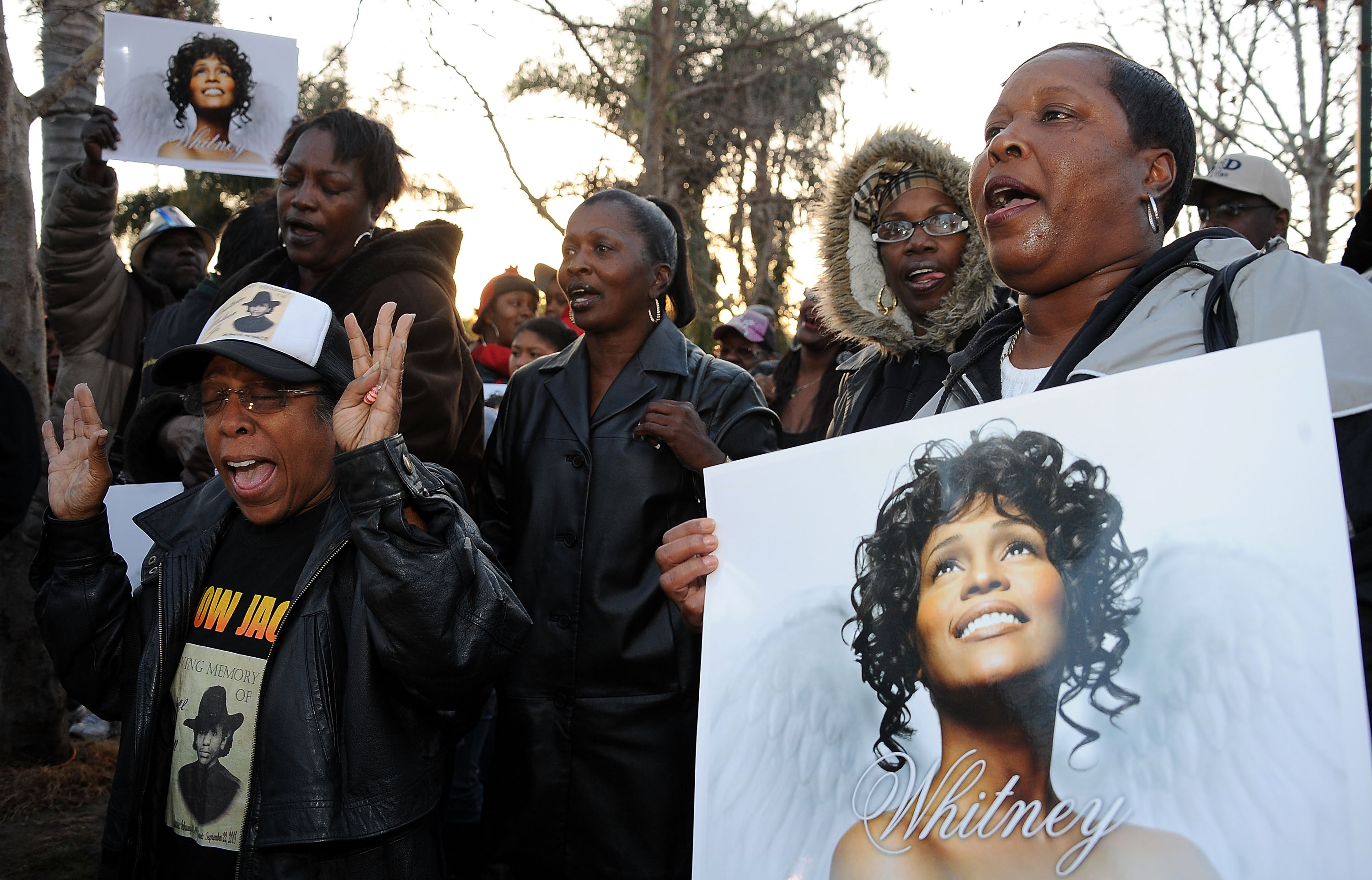 Fans holding Whitney Houston posters at her Leimert Park Vigil in Los Angeles, California on February 13, 2012 | Source: Getty Images