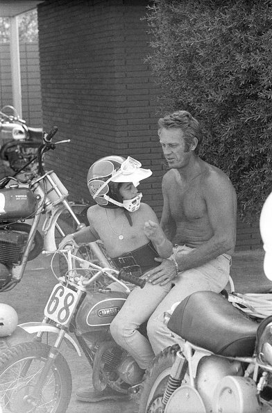 Portrait of celebrity actor Steve McQueen with his son, Chad McQueen, and his bike collection in his garage on June 13, 1971. | Photo: Getty Images