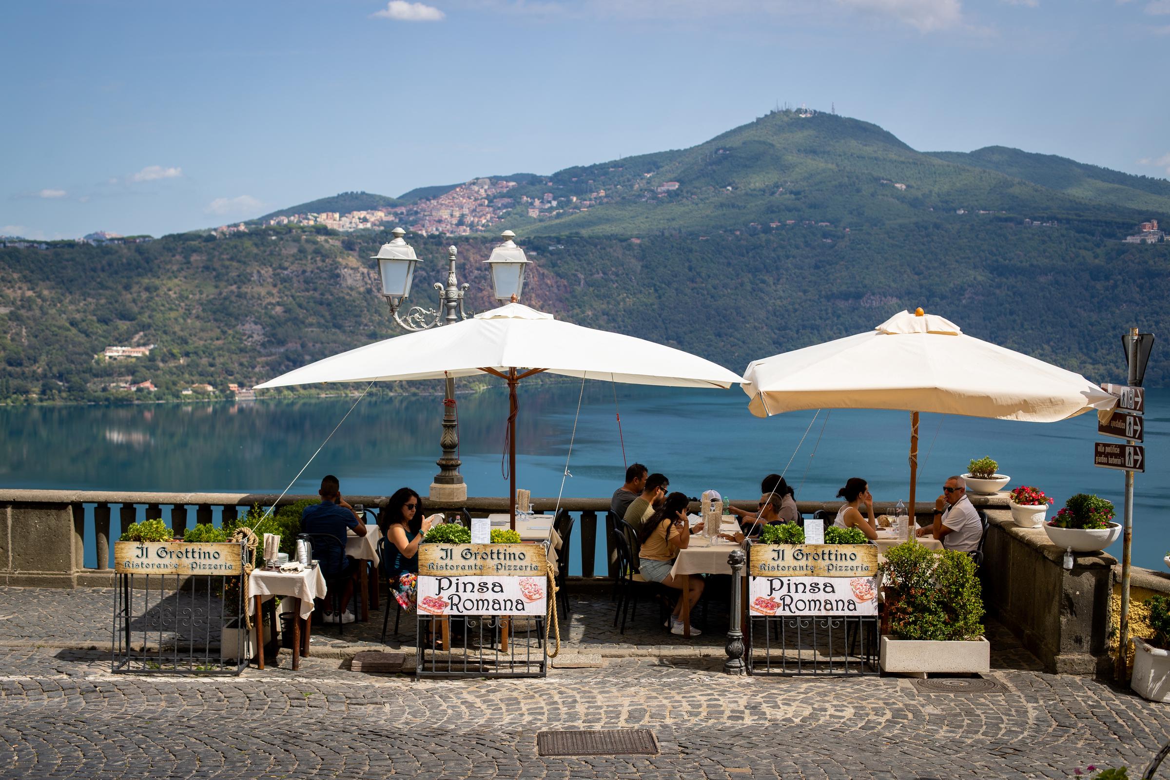 Tourists pictured at a local restaurant on September 6, 2022, in Castel Gandolfo, Italy. | Source: Getty Images
