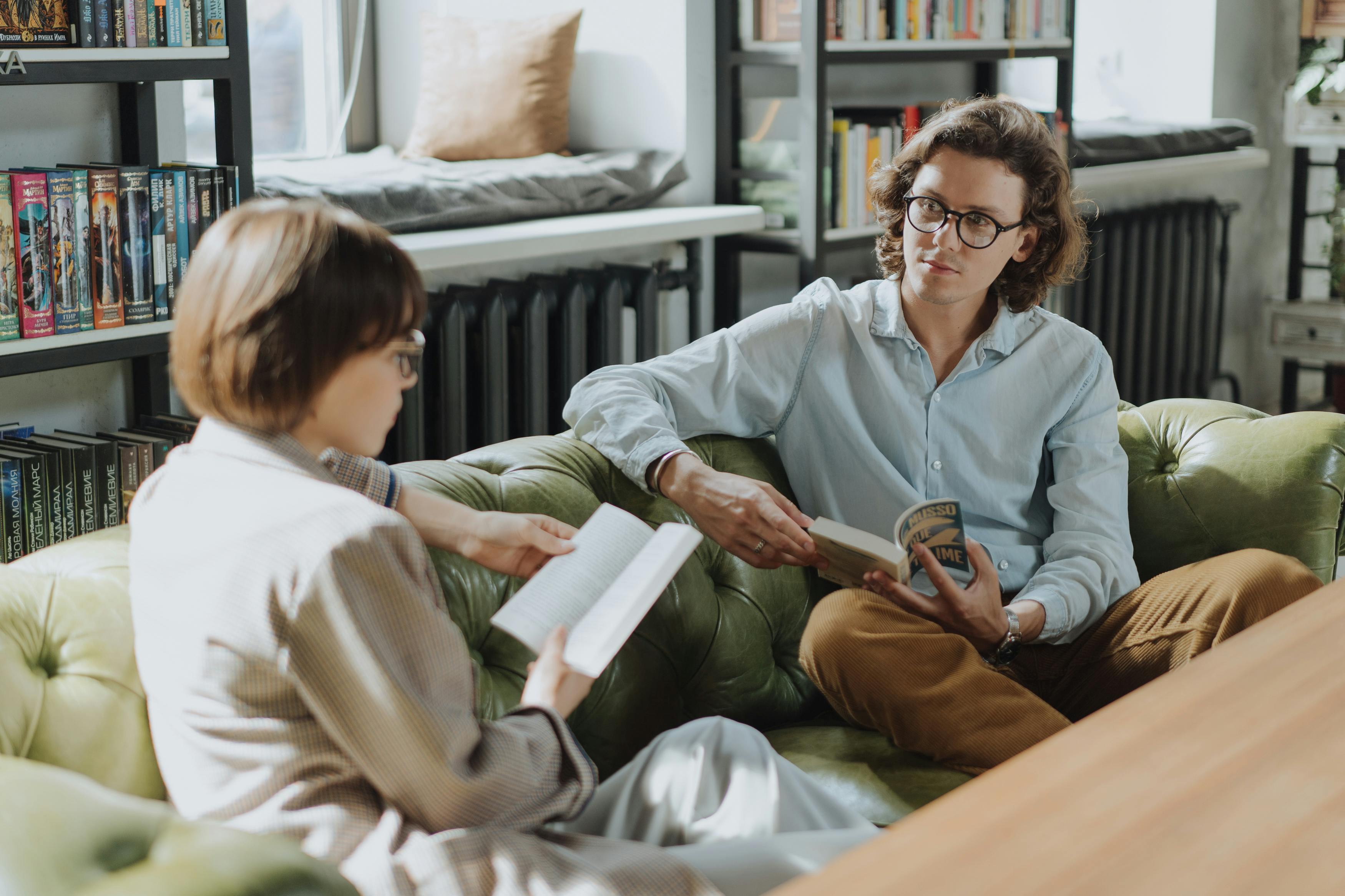 A couple reading books and talking | Source: Pexels