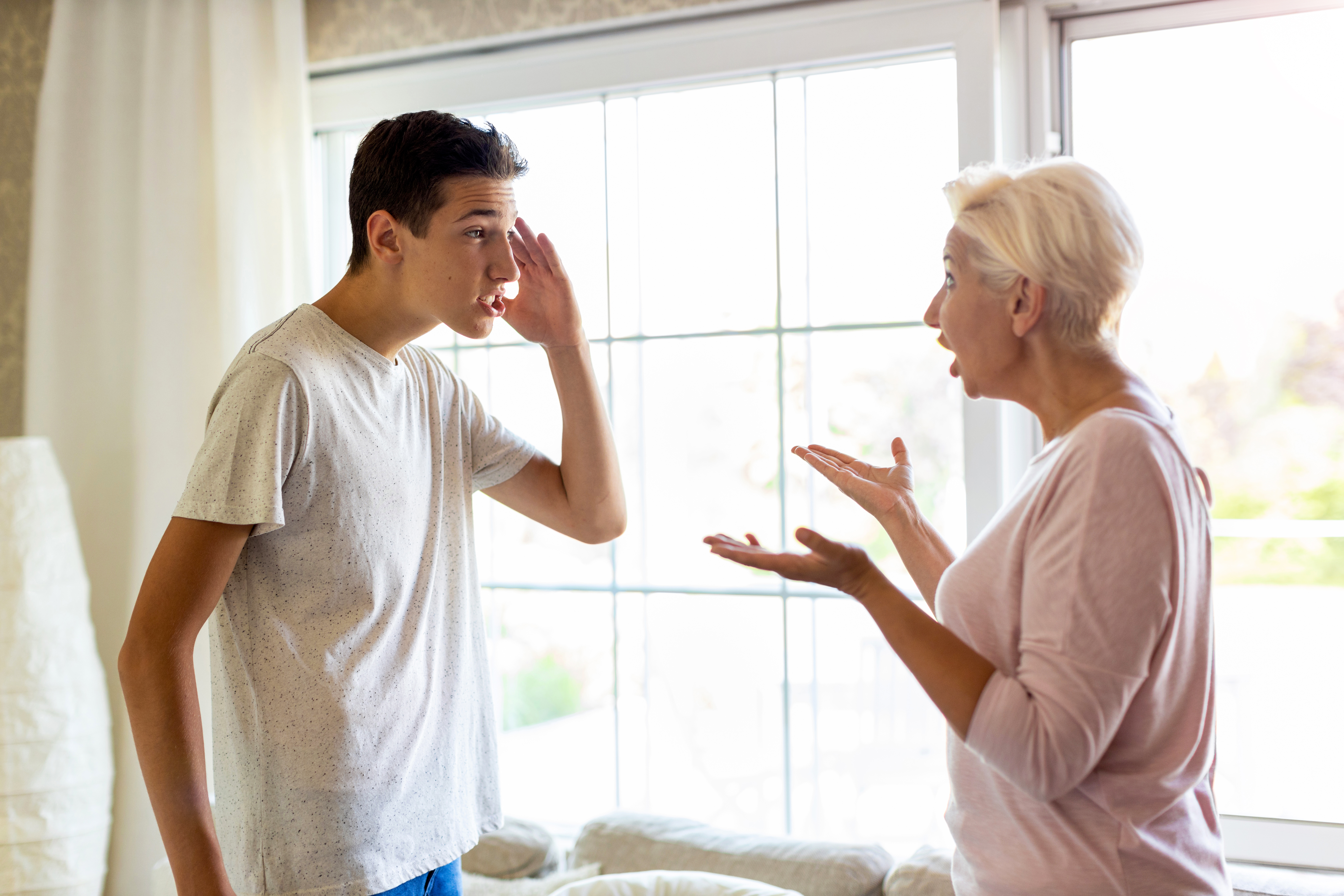 A woman and her teenage son yelling at each other | Source: Getty Images