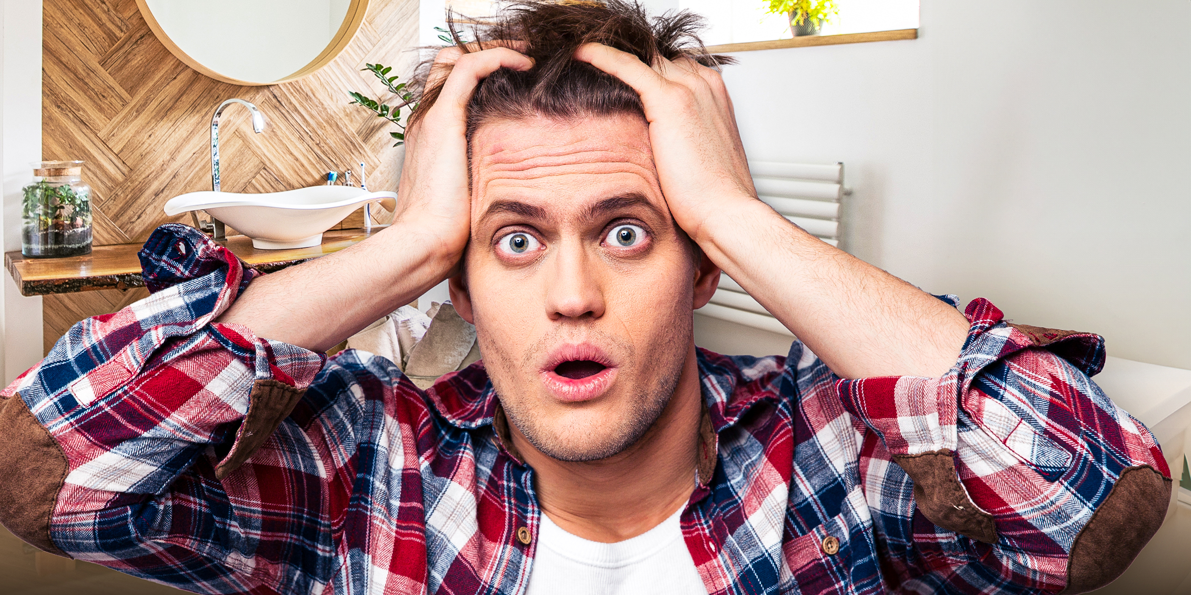 A man holding his head in shock | Source: Shutterstock