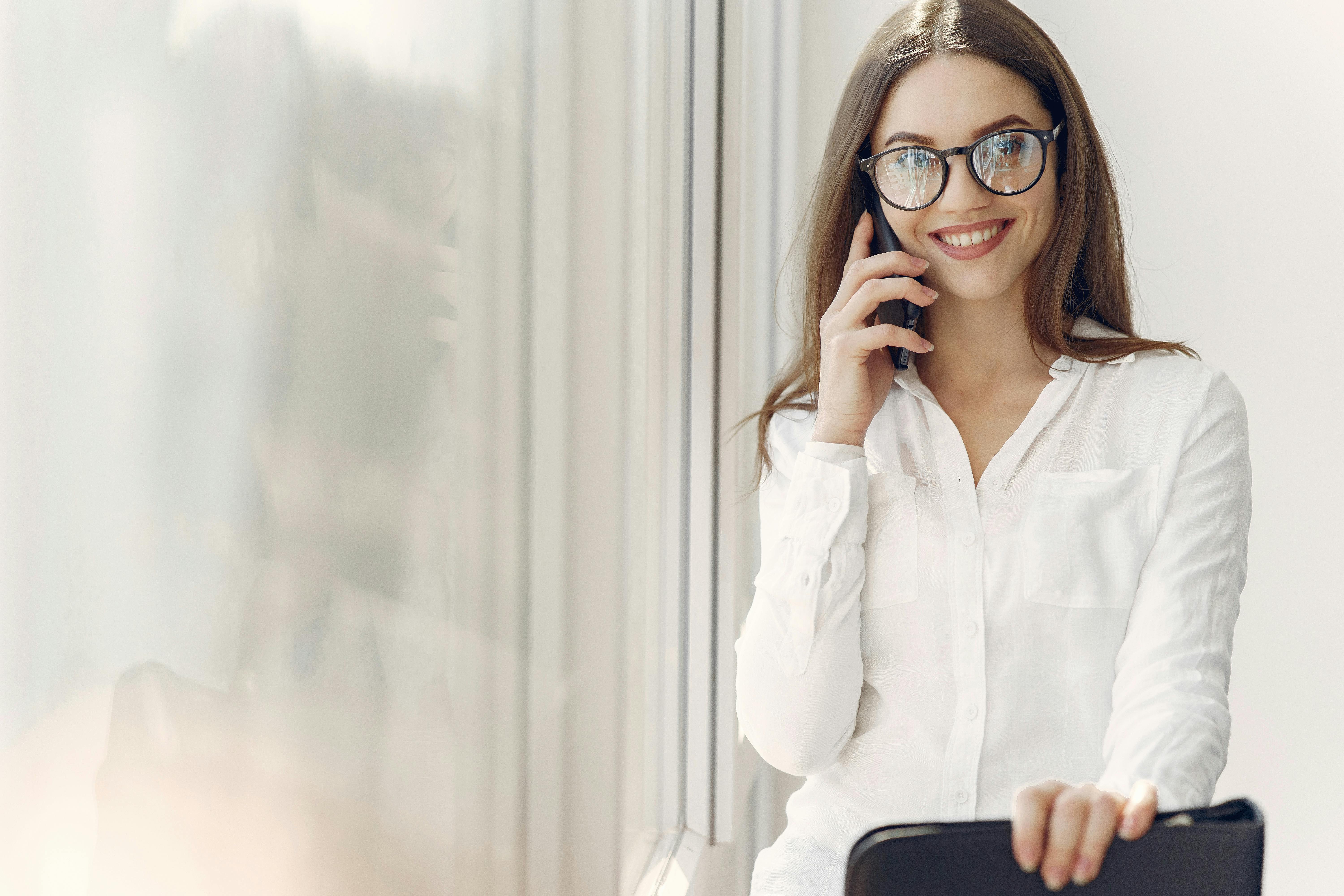 A smiling woman on a phone call | Source: Pexels