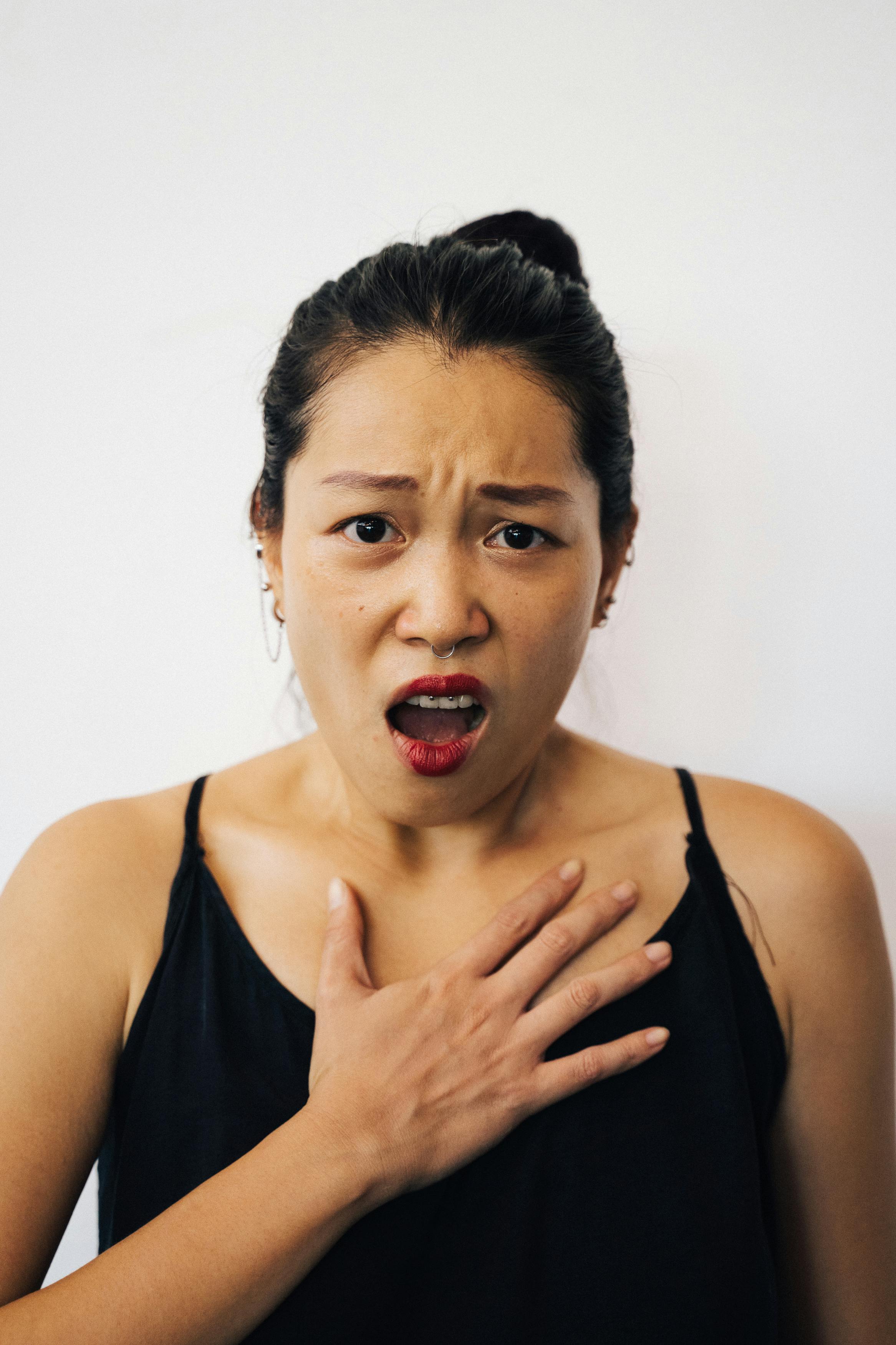 A shocked woman in a black top | Source: Pexels