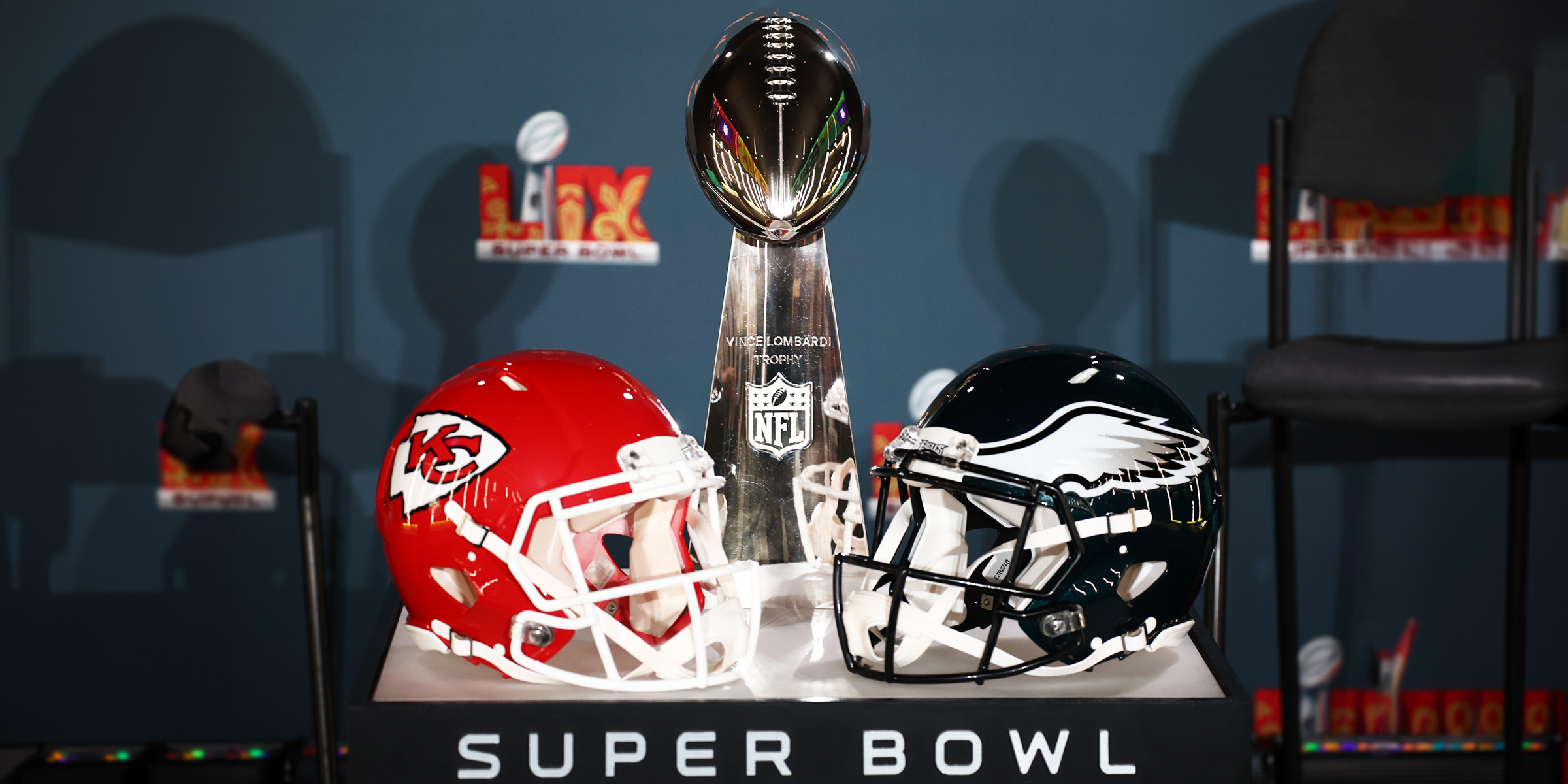 Kansas City Chiefs and Philadelphia Eagles football helmets and the Super Bowl trophy. | Source: Getty Images