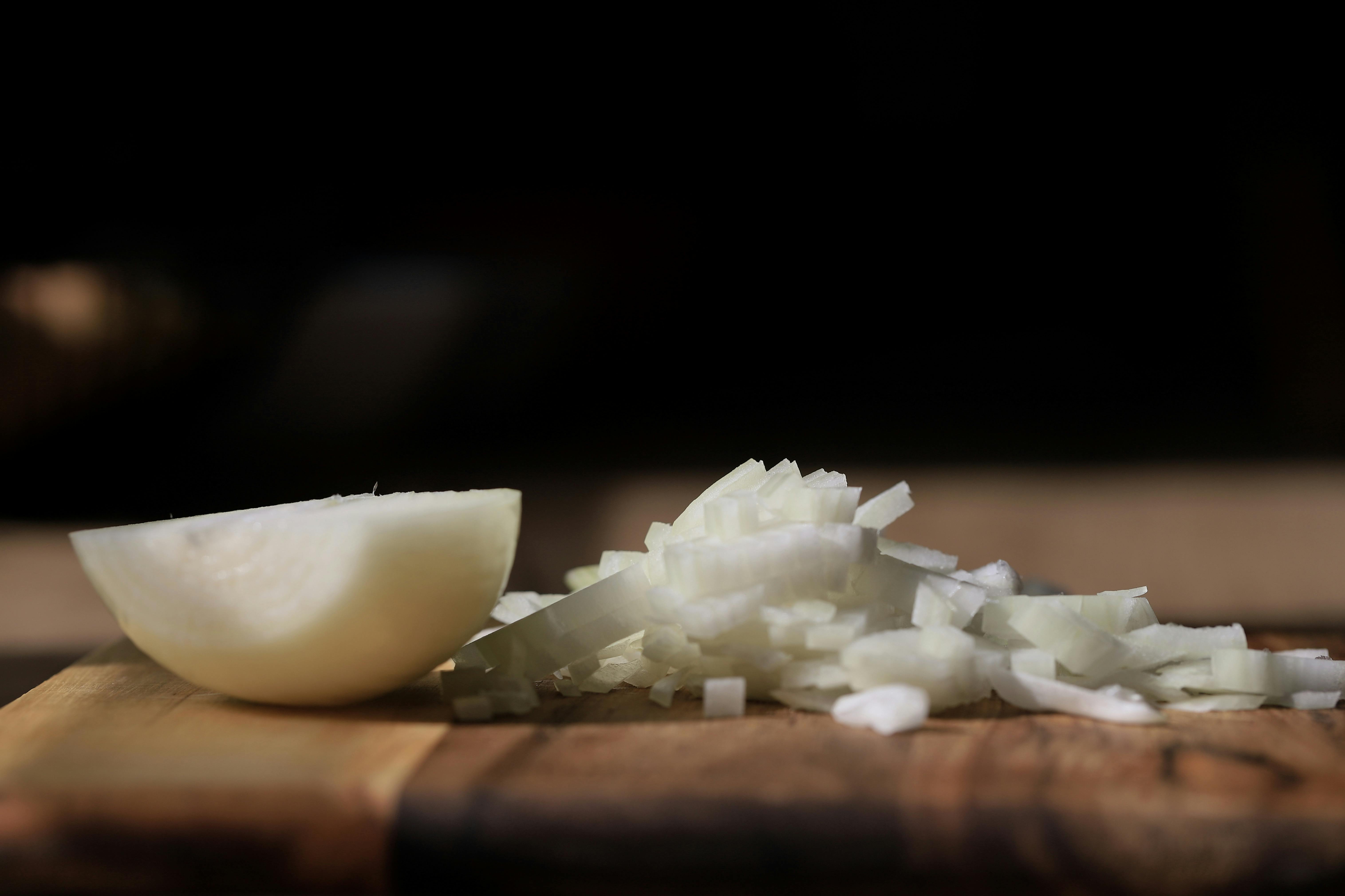 Sliced onions on a cutting board. | Source: Pexels