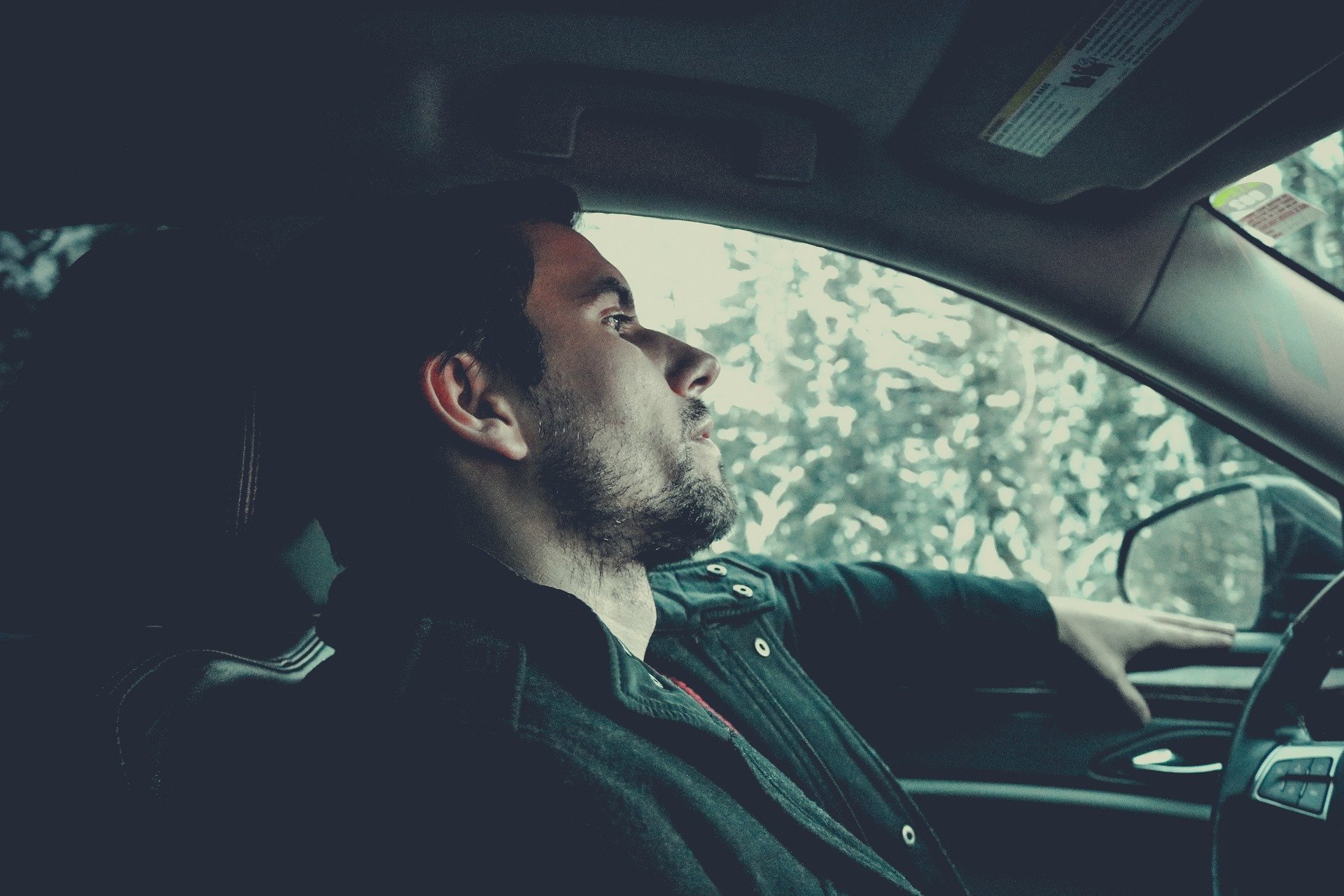 Pictured - A young man in deep thoughts while inside a car | Source: Pixabay
