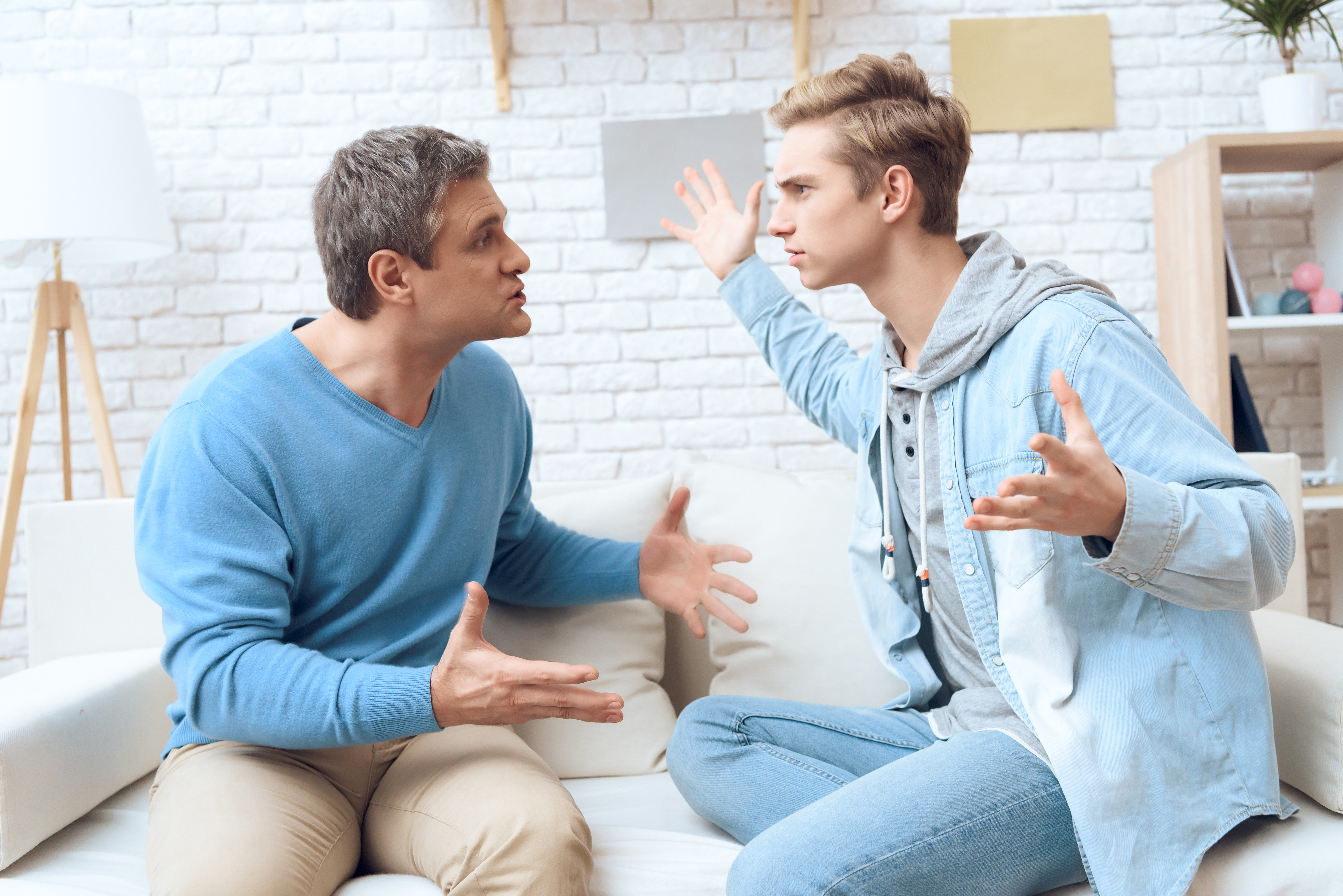 A father-son duo is pictured having an argument | Source: Shutterstock