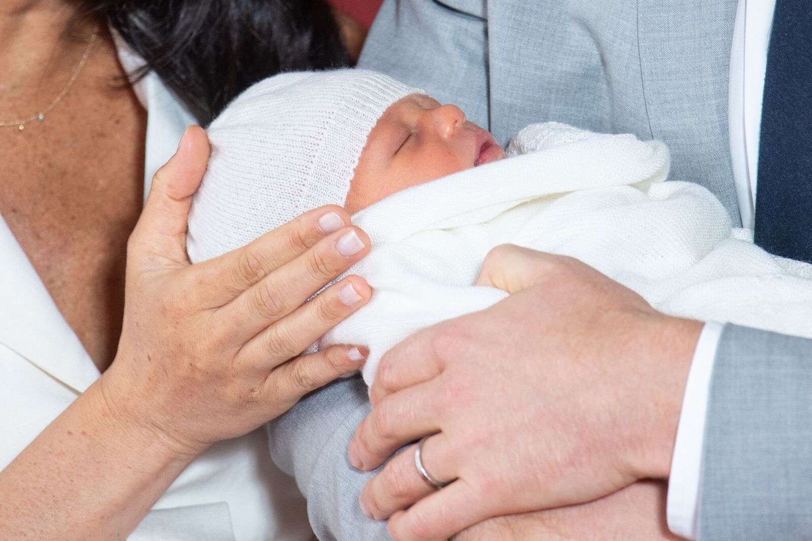 Meghan et son mari portant l'enfant dans ses bras. | Photo : GettyImage Meghan et son mari portant l'enfant dans ses bras. | Photo : GettyImage