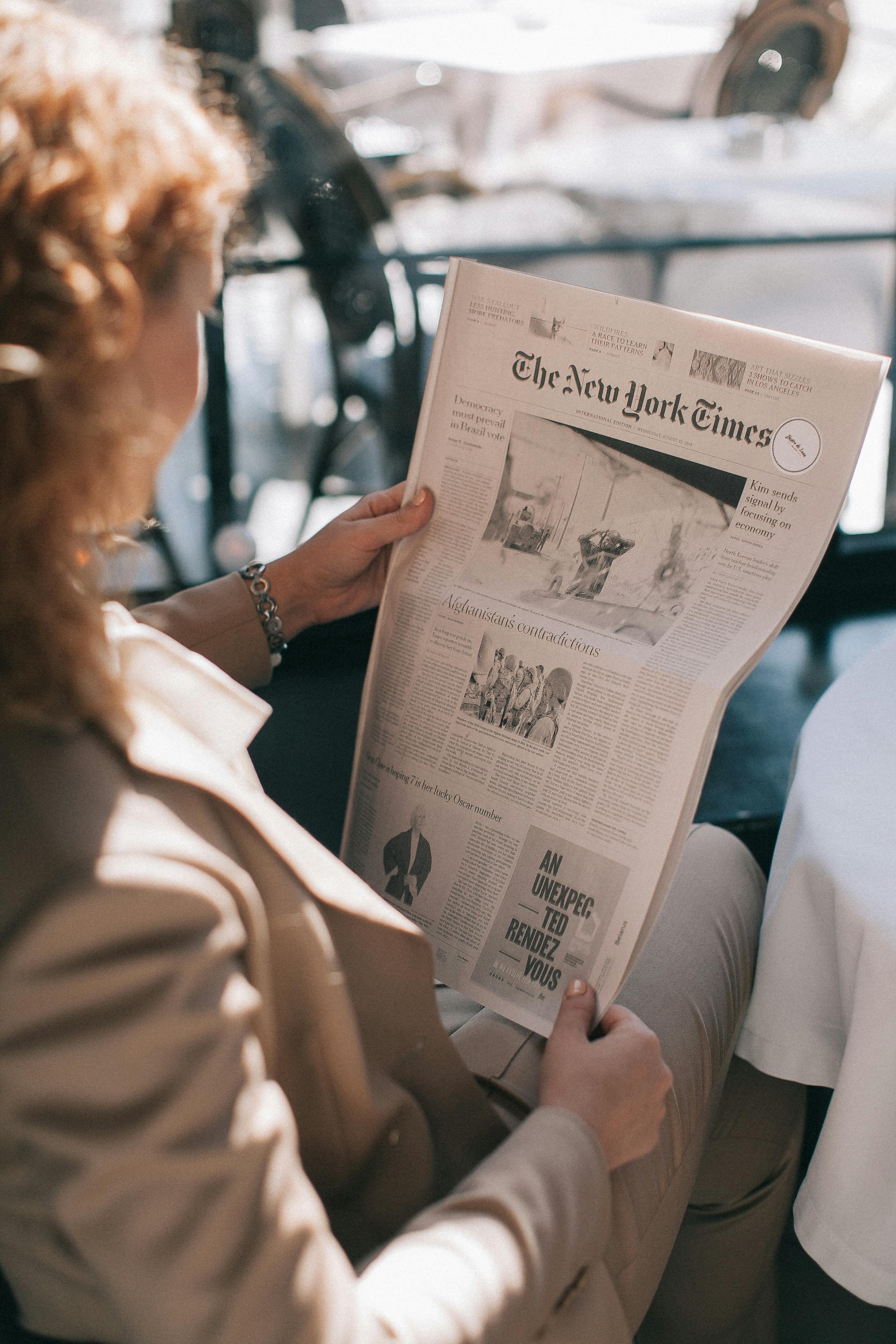 A person reading a newspaper | Source: Pexels