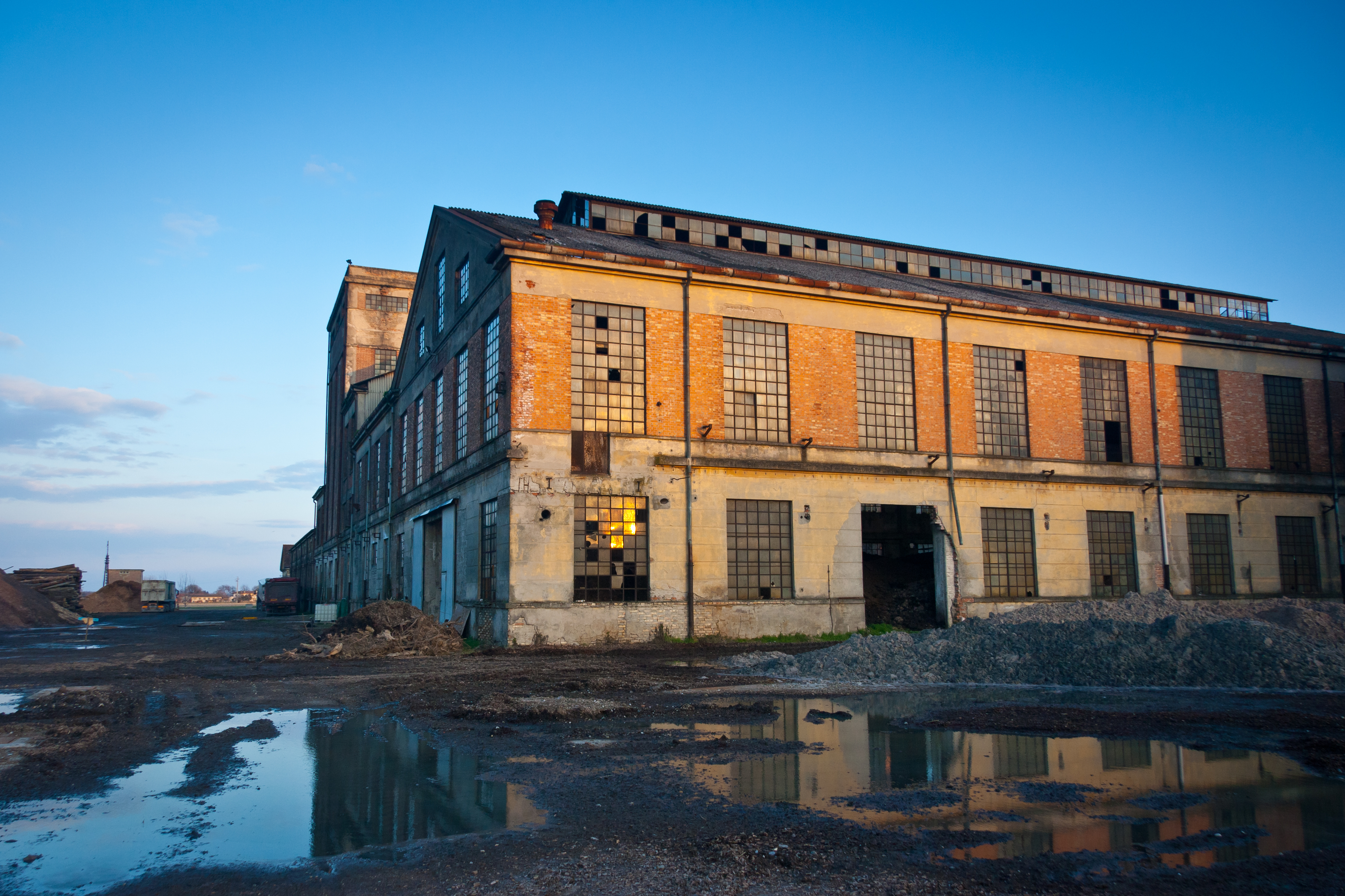 Abandoned industrial plant at sunset. | Source: Shutterstock