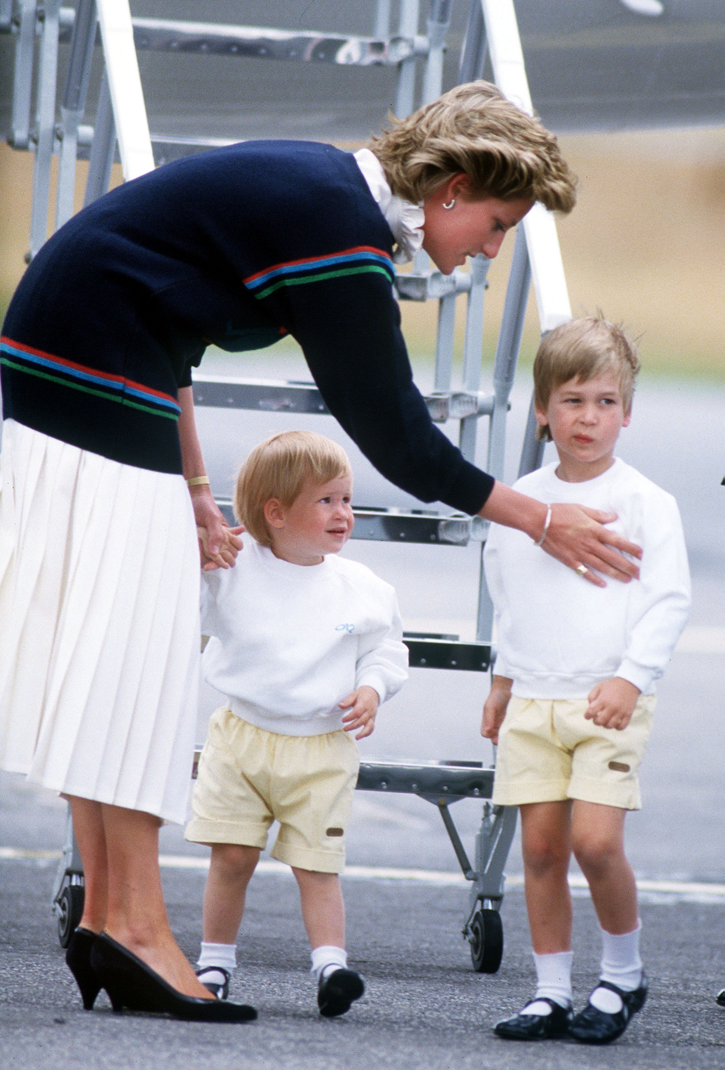 Princess Diana arriving at Aberdeen airport with her sons princes William and Harry for a holiday at Balmoral Castle in August 1986. / Source: Getty Images