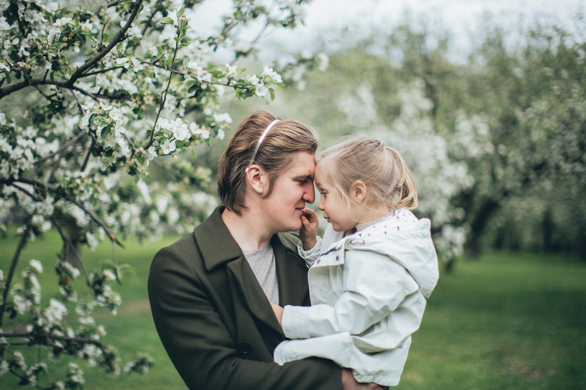A father and daughter hugging near a tree | Source: Pexels