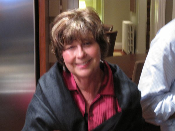 In a blurry shot, Nancy Guthrie takes photo in a red and black outfit, from a post dated March 6, 2012. | Source: Facebook/NancyGuthrie