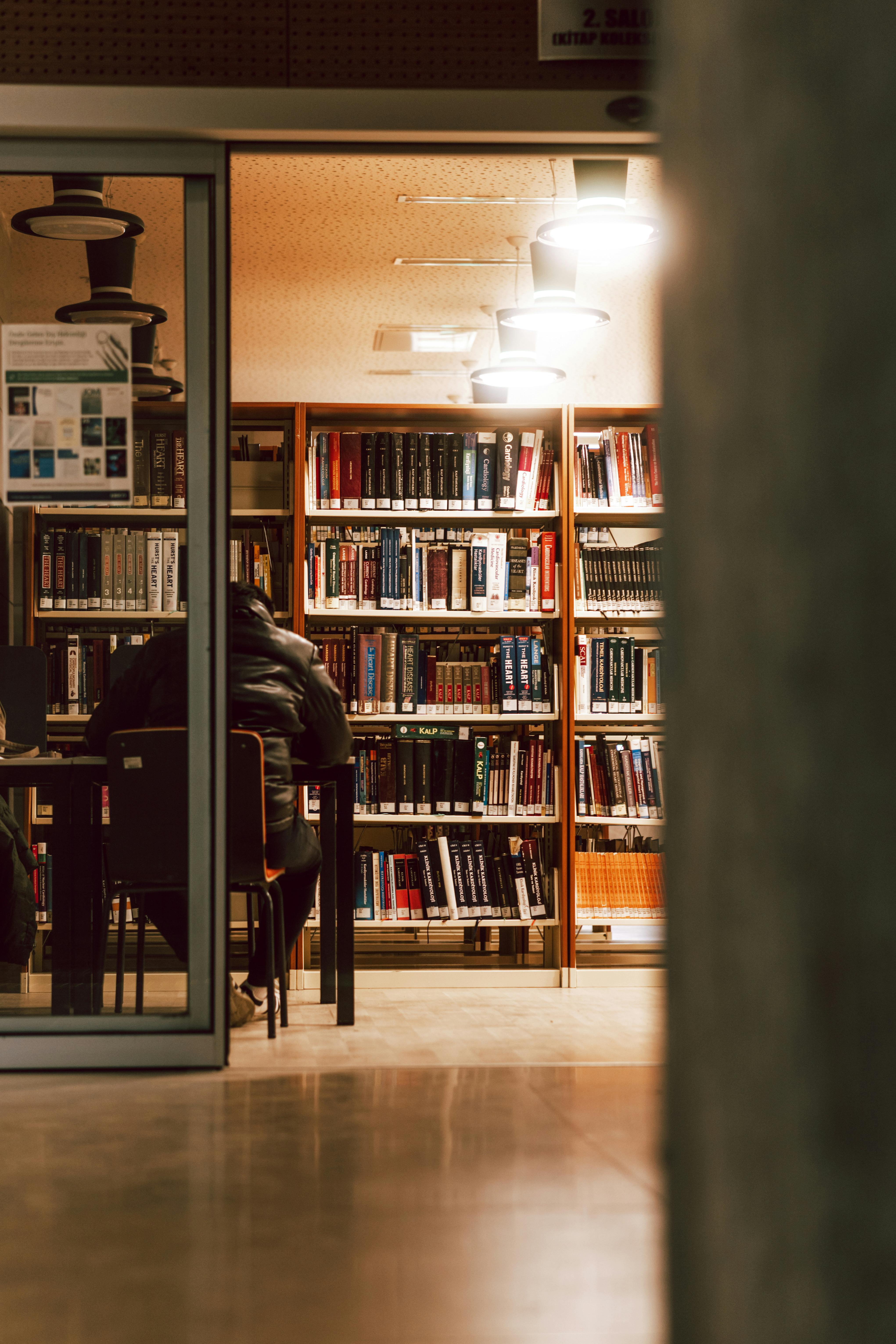A man sitting in a bookstore | Source: Pexels
