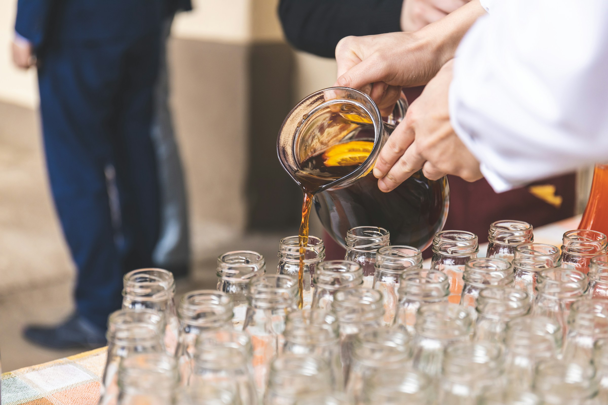 A person filling a glass bottle | Source: Unsplash