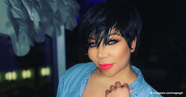 Tiny turns heads with her new short hairdo while showing off tattoos in denim jacket