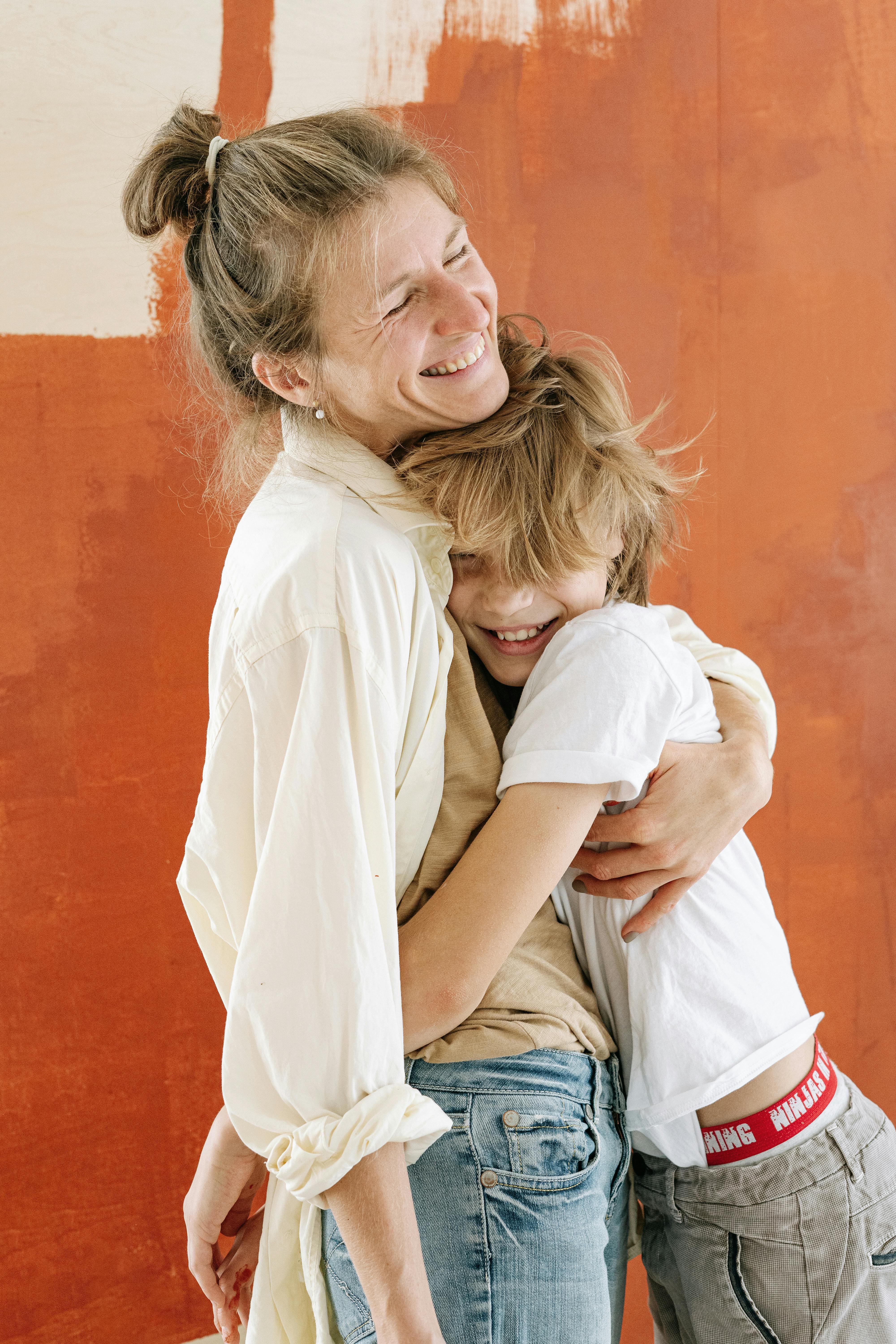 A happy woman hugging a boy | Source: Pexels