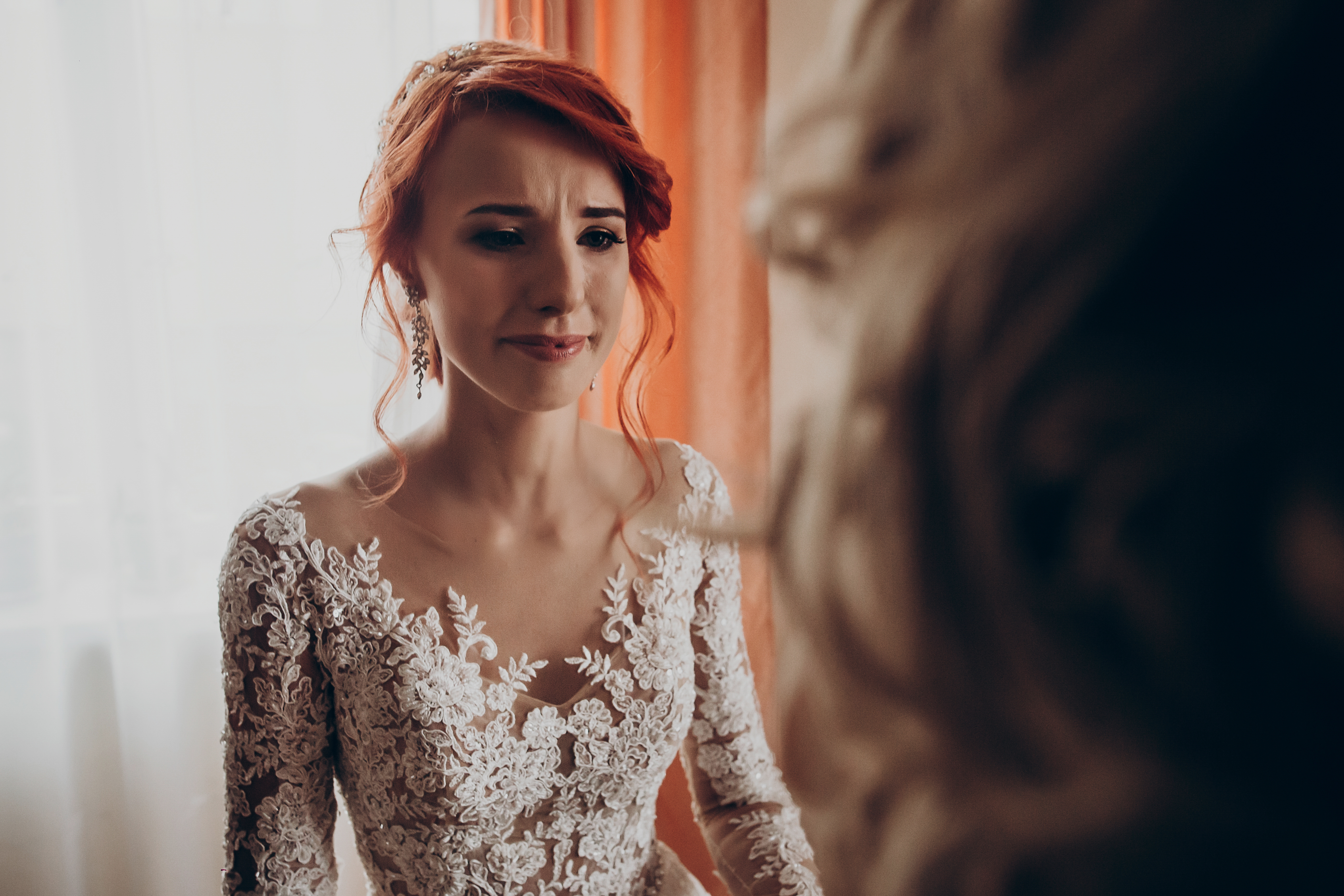 A bride tears down while looking at her family | Source: Shutterstock