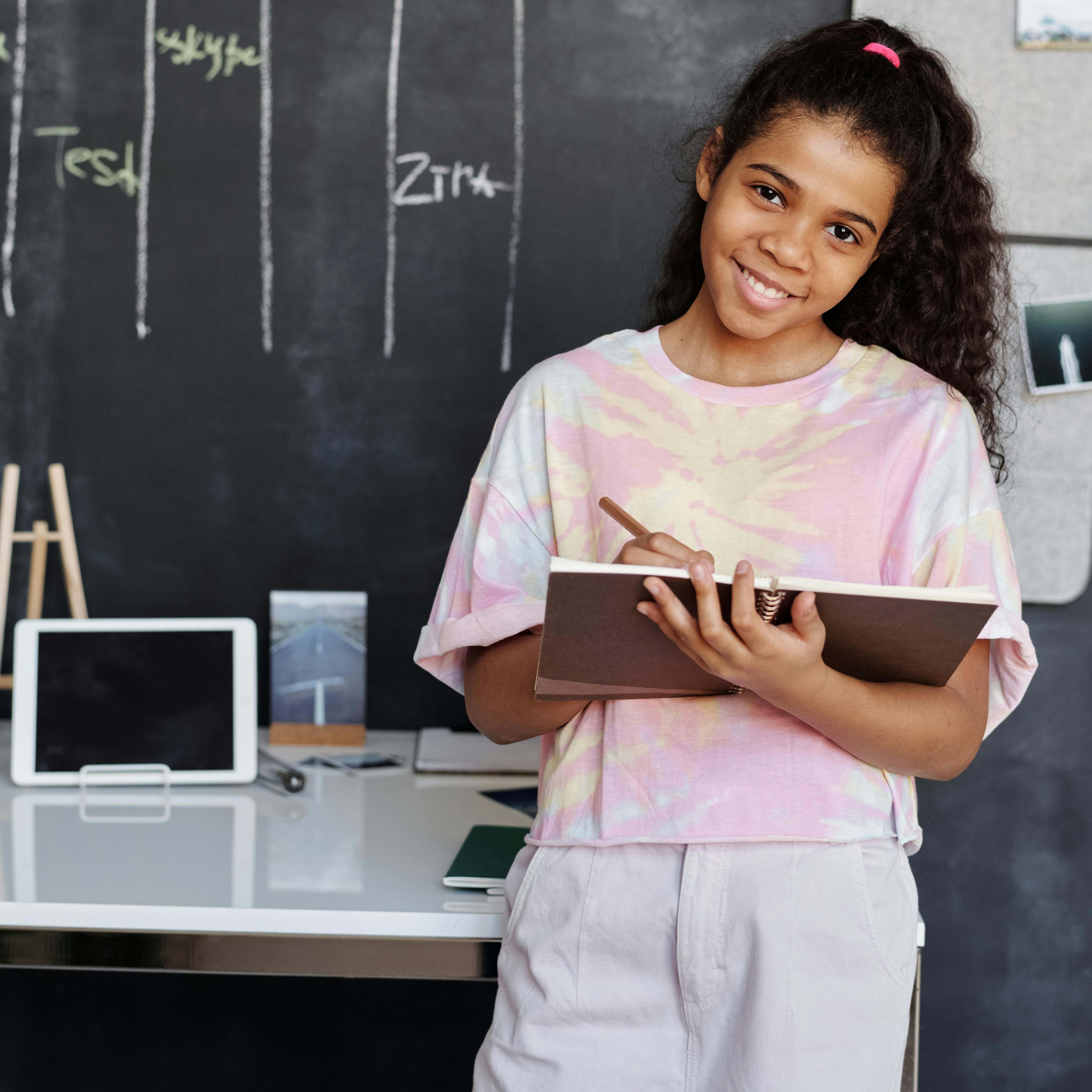 A young girl posing in a school classroom | Source: Pexels