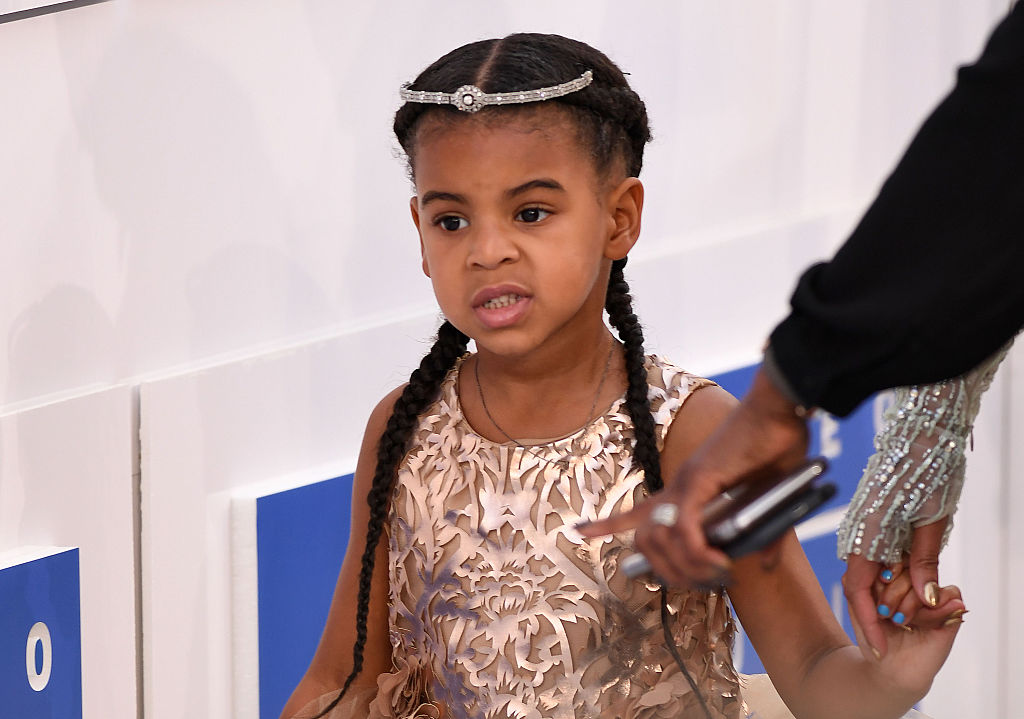 In this image from the same event, Blue Ivy Carter can be seen with an inquisitive, slightly disgusted look on her face. Her hair was done in tight braids and she wore a jeweled headband.