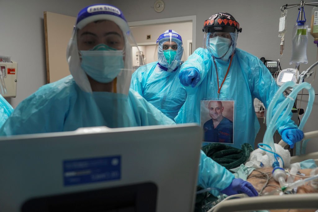 Medical staff members including Dr. Joseph Varon  examine a patient in the COVID-19 intensive care unit (ICU) at the United Memorial Medical Center on December 2, 2020 in Houston, Texas. | Photo: Getty Images