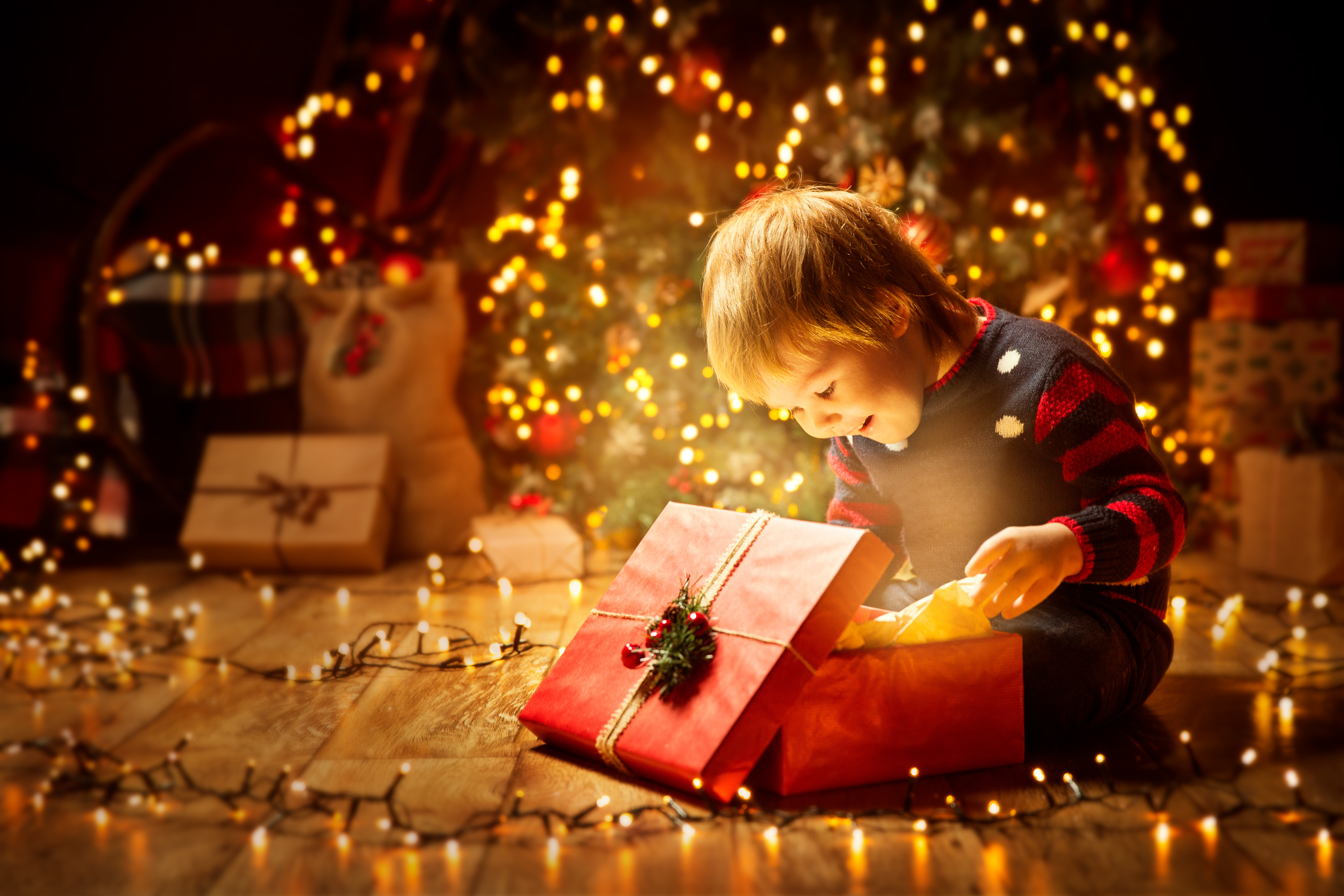 A boy opening a Christmas gift box | Source: Shutterstock