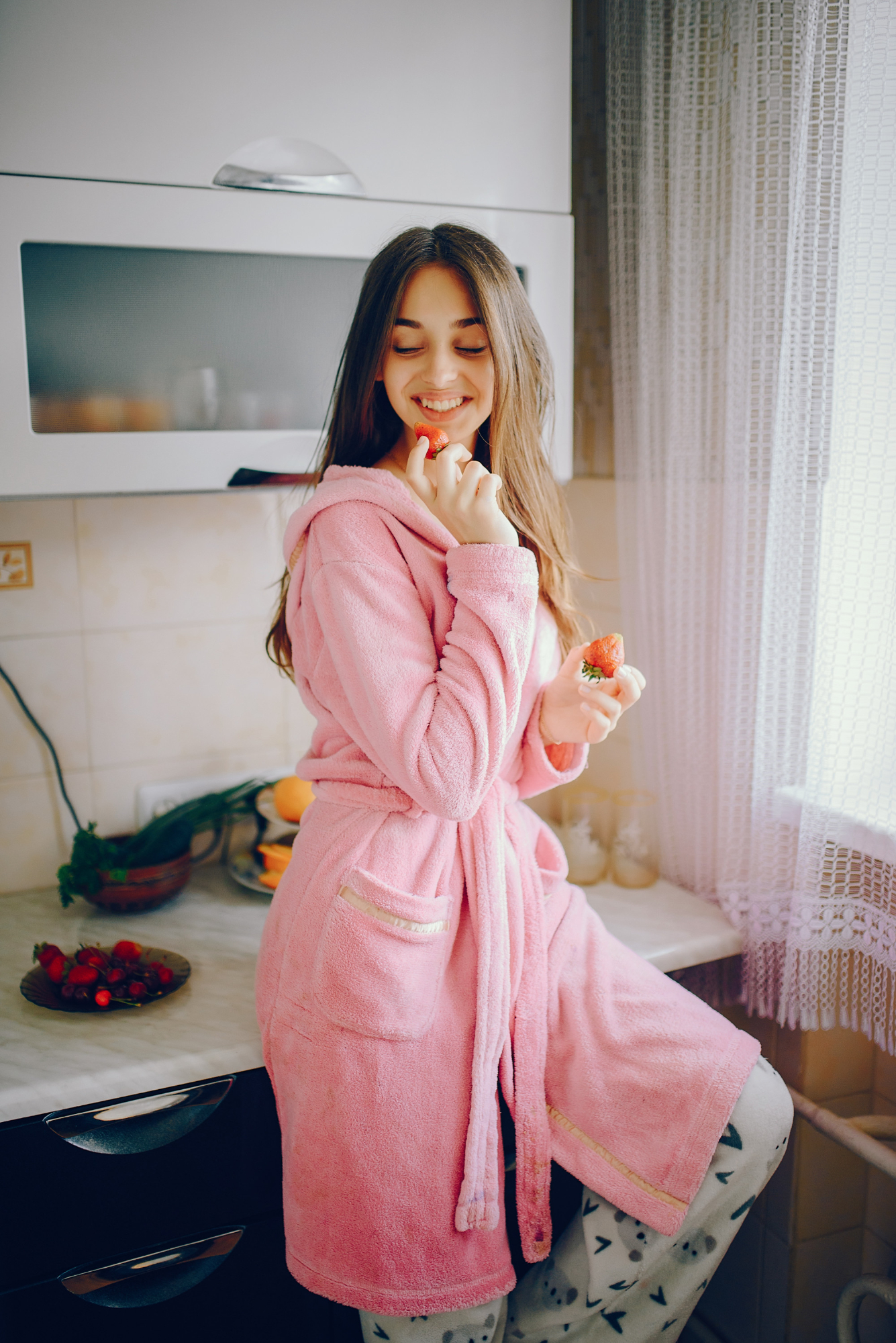 A woman smiling while dressed in a gown and pajamas | Source: Freepik