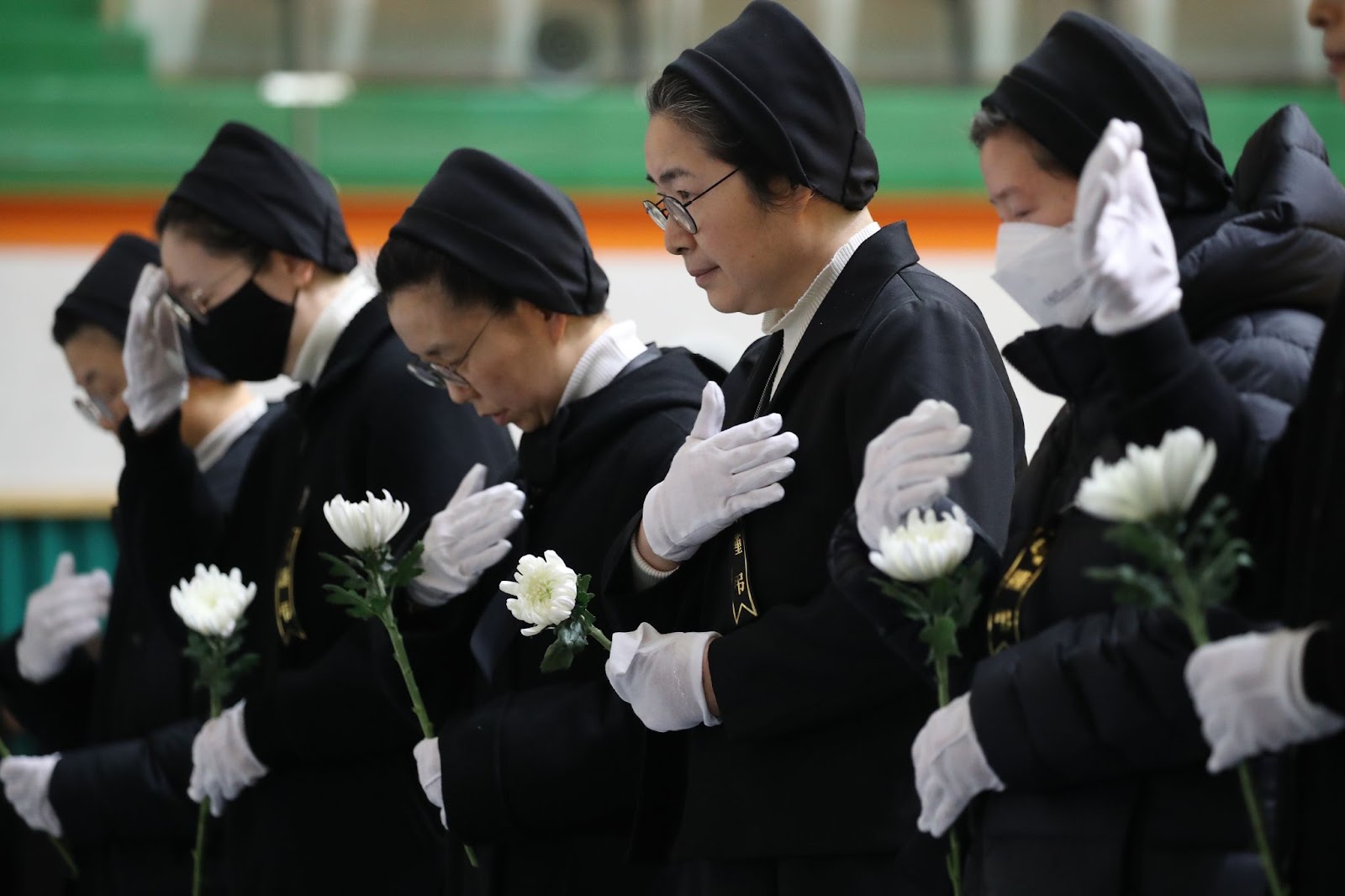 South Korean nuns paying tribute at a group memorial altar for victims of Flight 7C2216 at the Muan sports park on December 30, 2024, in Muan-gun, South Korea. | Source: Getty Images